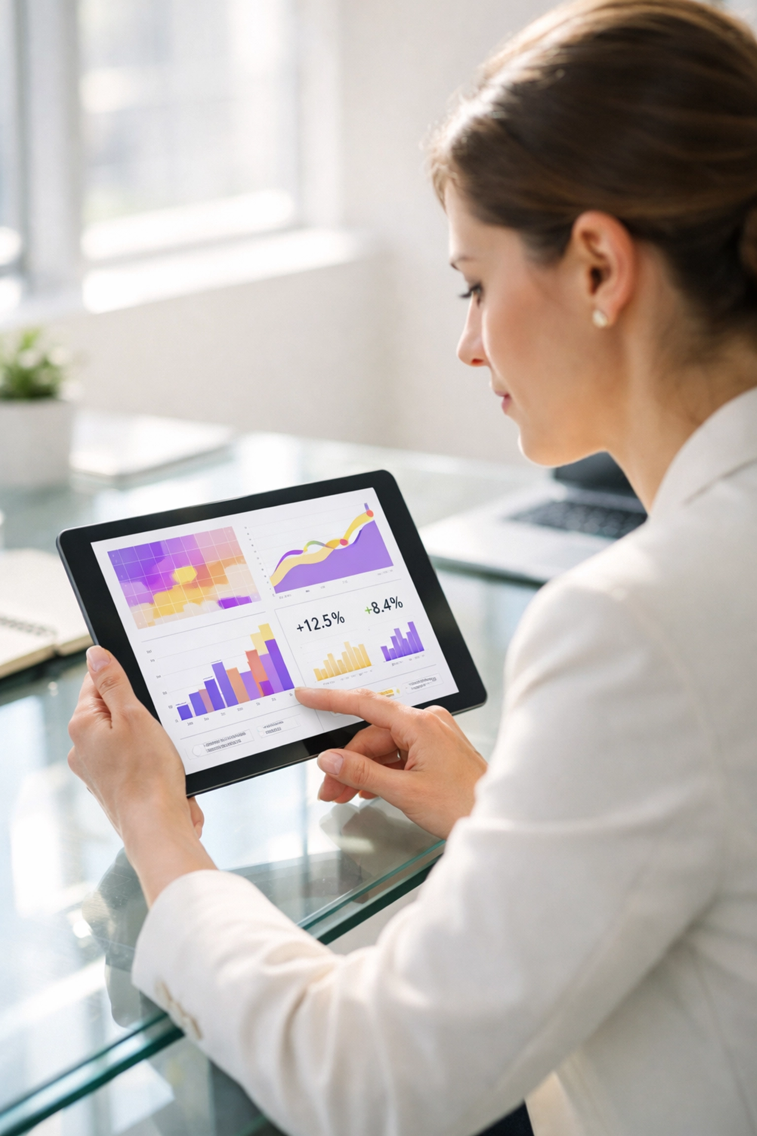 Professional analyzing growth marketing data and website heatmaps on a digital tablet in a modern office.