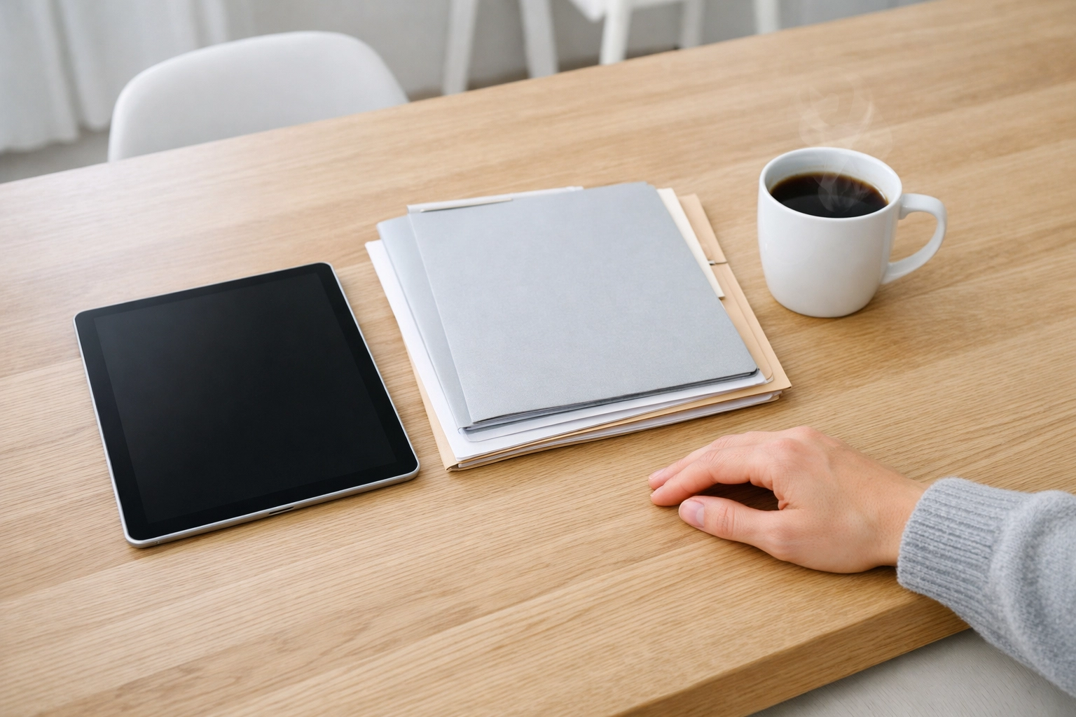 Organized paperwork and a tablet on a kitchen table for a home loan pre-qualification process.
