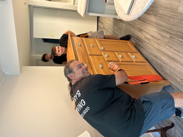 Betsy's Moving Team Maneuvering Dresser