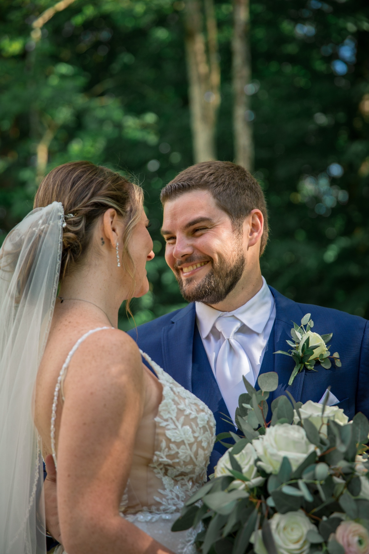 Telephoto portrait of Tyler looking at Samantha with a joyful, loving expression