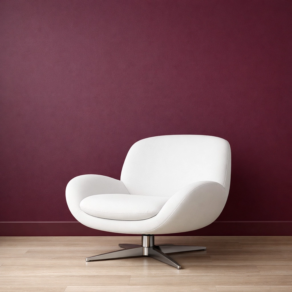 Luxury interior featuring a rich Divine Damson burgundy accent wall and minimalist furniture.