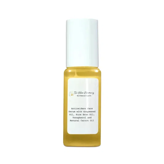 Antioxidant face serum with carrot oil in a clear glass bottle