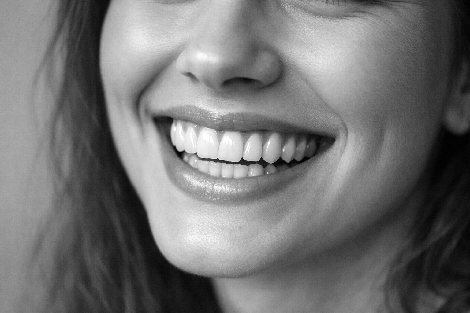 Happy patient showing straight teeth after successful orthodontic treatment completion