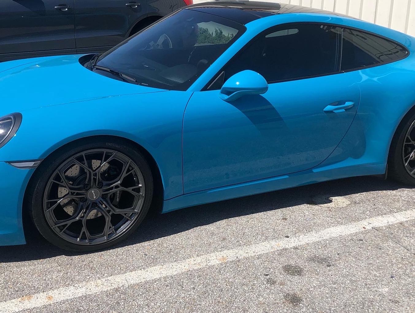 Blue Porsche 911 featuring custom gloss black powder coated brake calipers