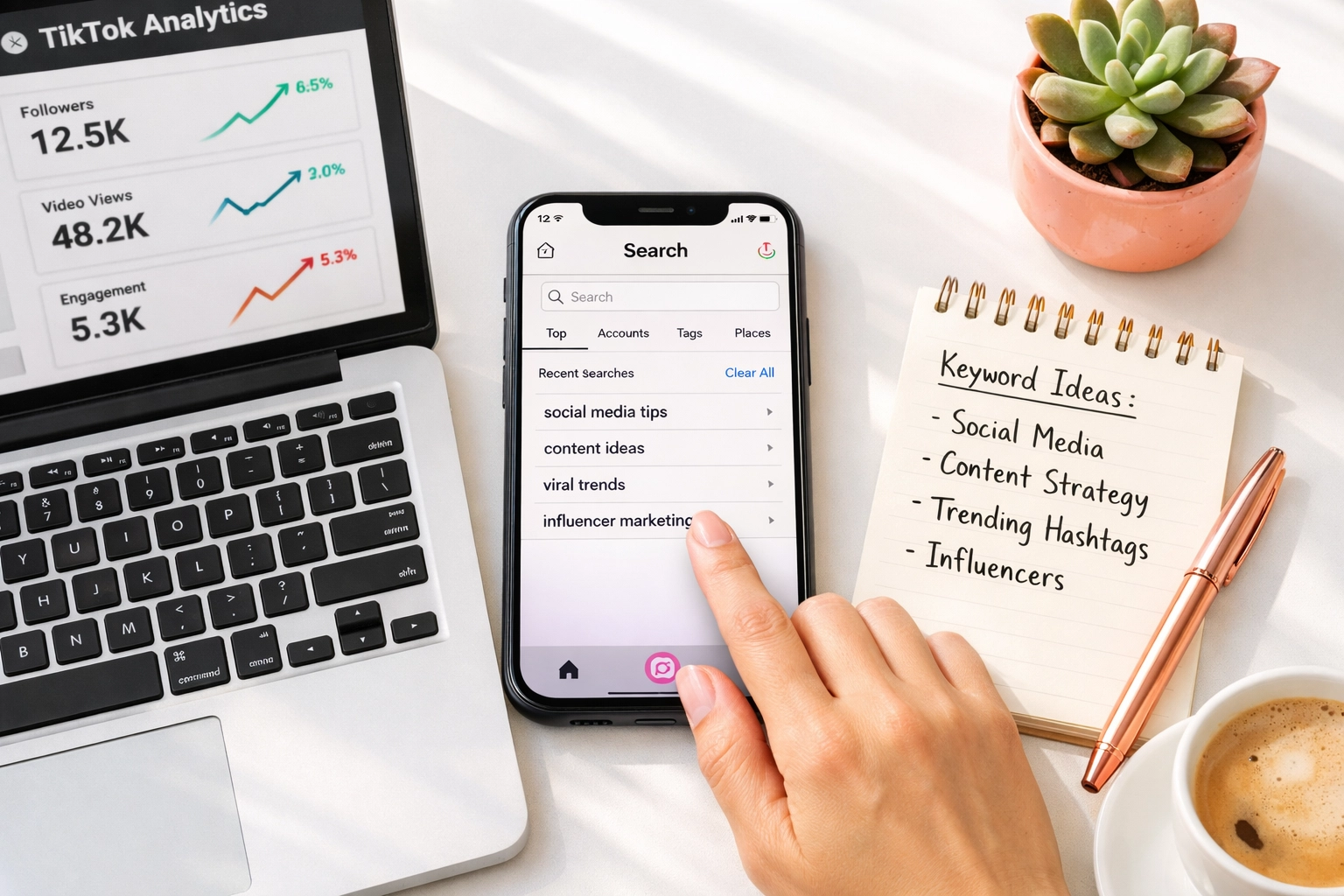 Social media workspace with smartphone showing Instagram search and keyword planning notes