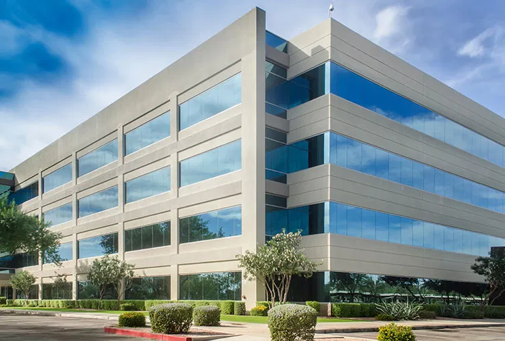 A contemporary four-story commercial office building representing the professional management of business properties.