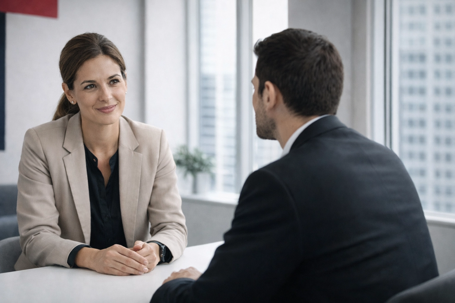 Professional displaying active listening skills in a modern office to improve workplace communication.