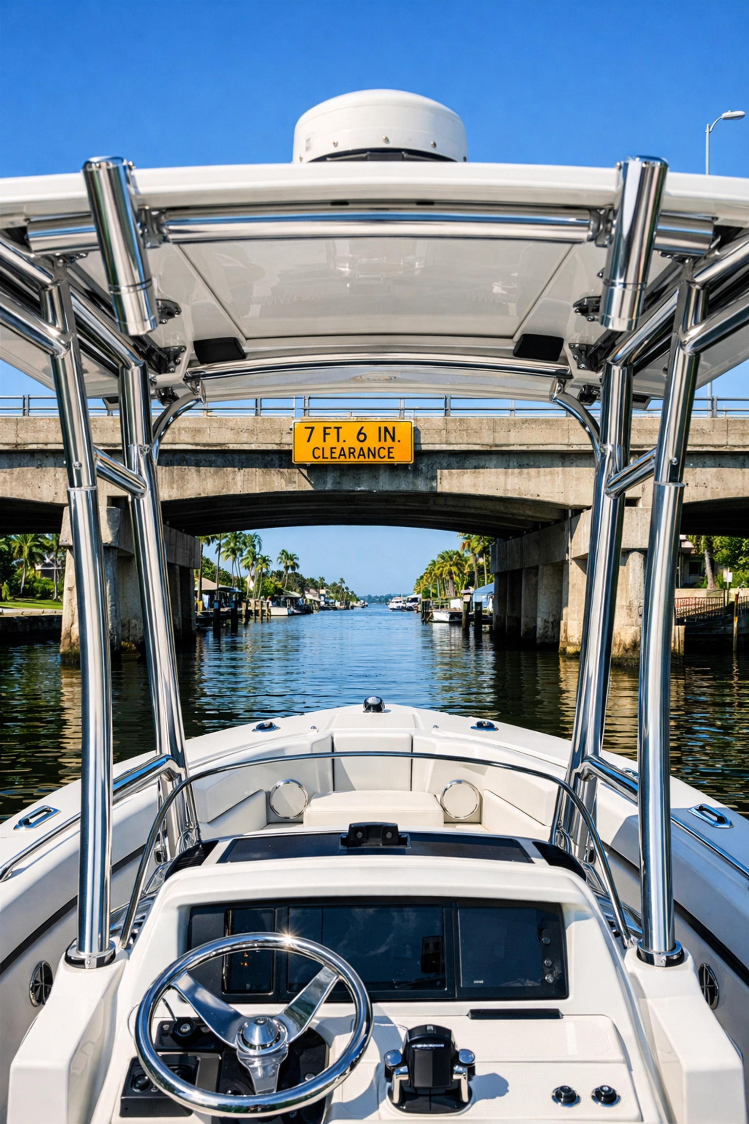 A boat approaching a concrete bridge in a Florida canal to check bridge clearance heights.