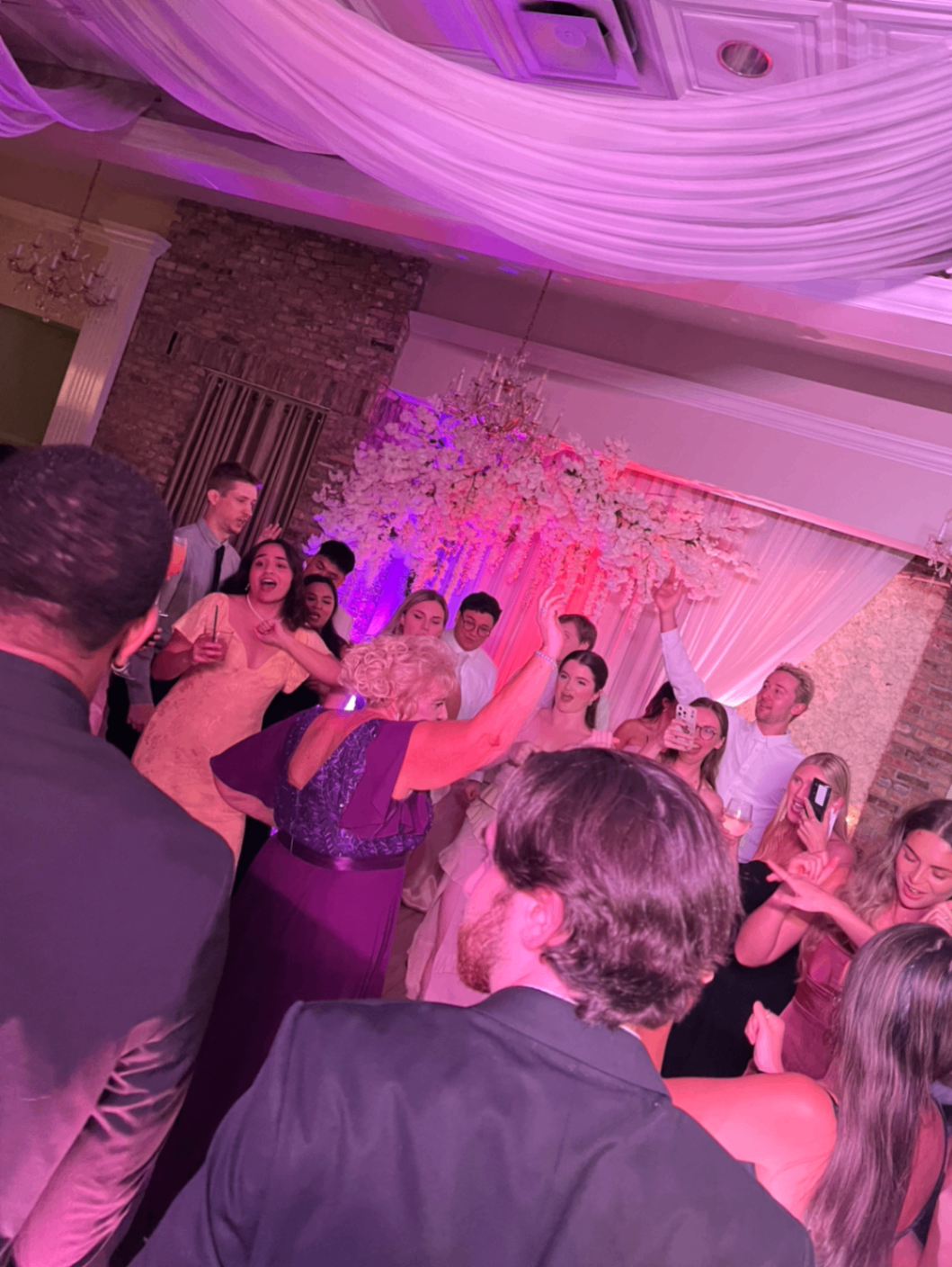 Guests on dance floor with DJ and lighting services
