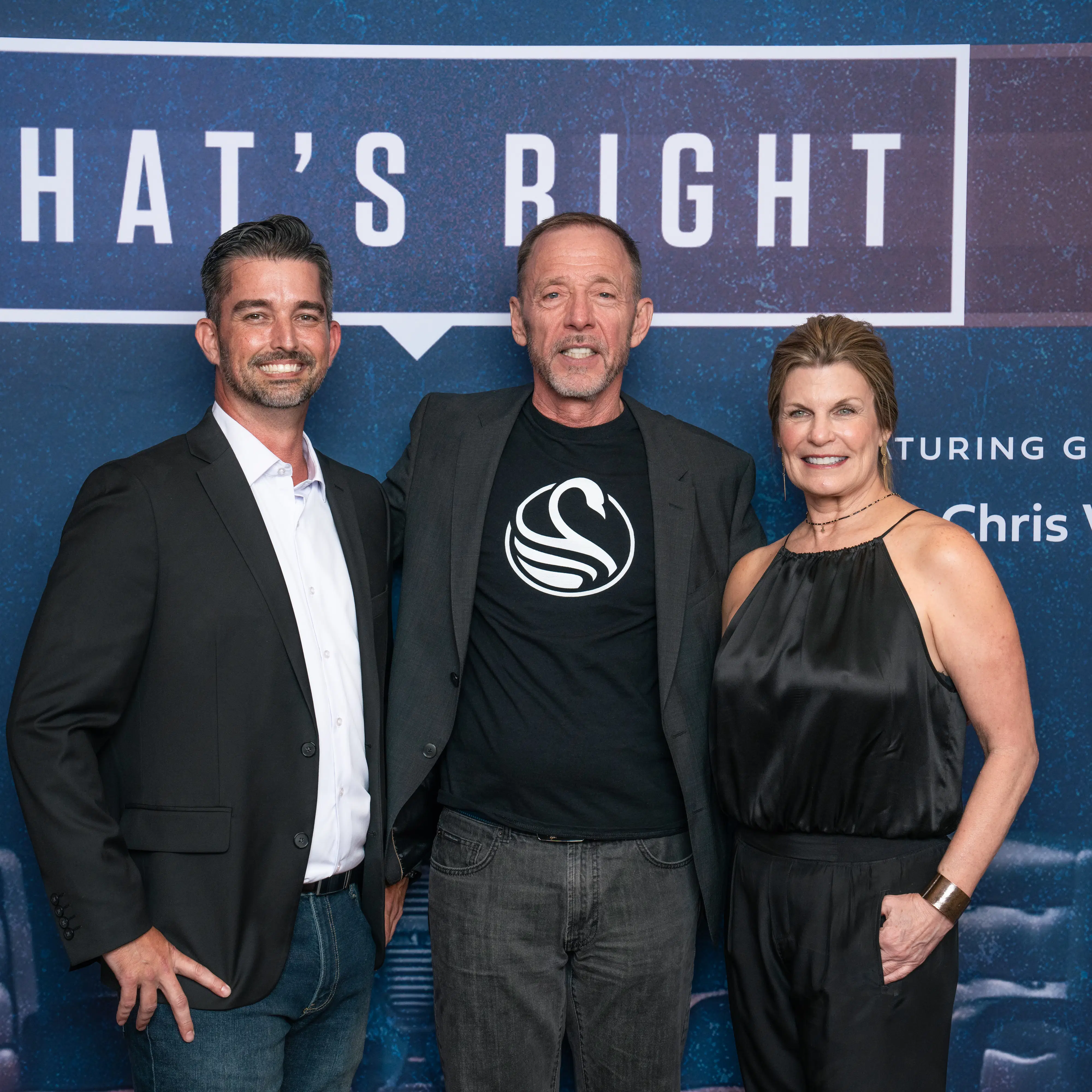 Three well-dressed professionals, including Coach JT, pose together at a branded event backdrop reading “What’s Right.”