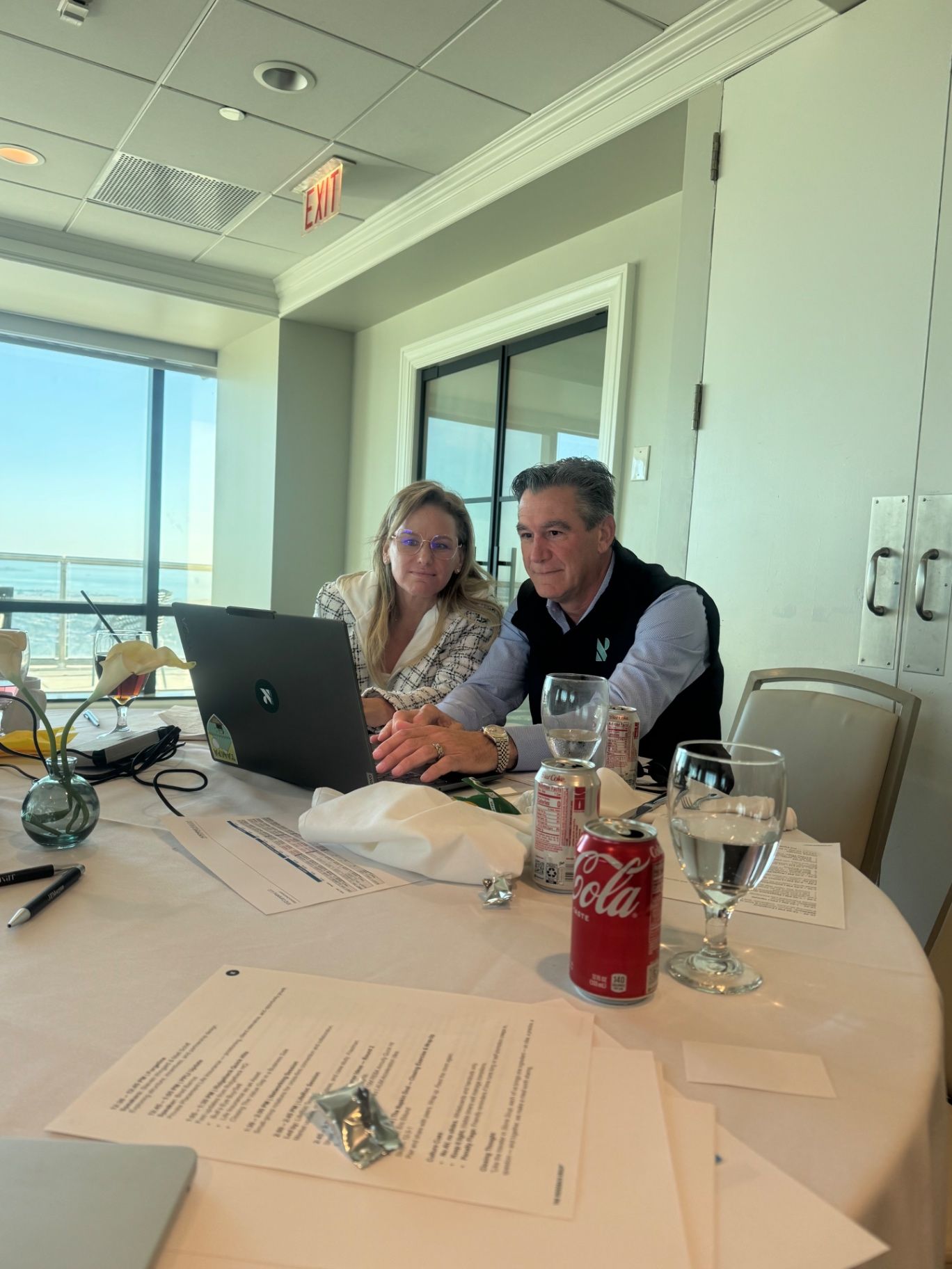 Executive team in a collaborative meeting focused on benefit structure, empathy, and retention culture.