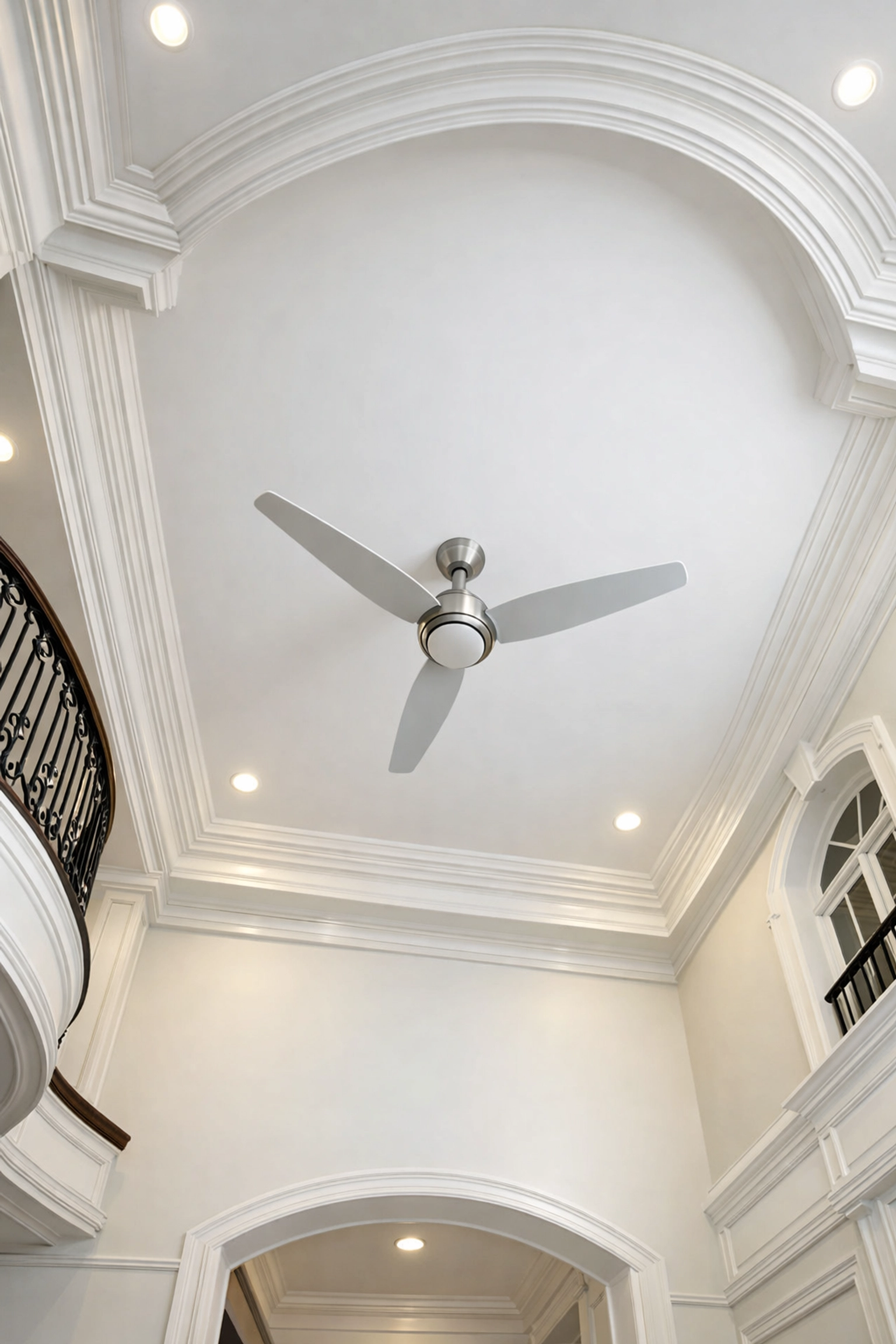 Dust-free ceiling fan and crown molding in a grand foyer after professional deep cleaning in Southborough.
