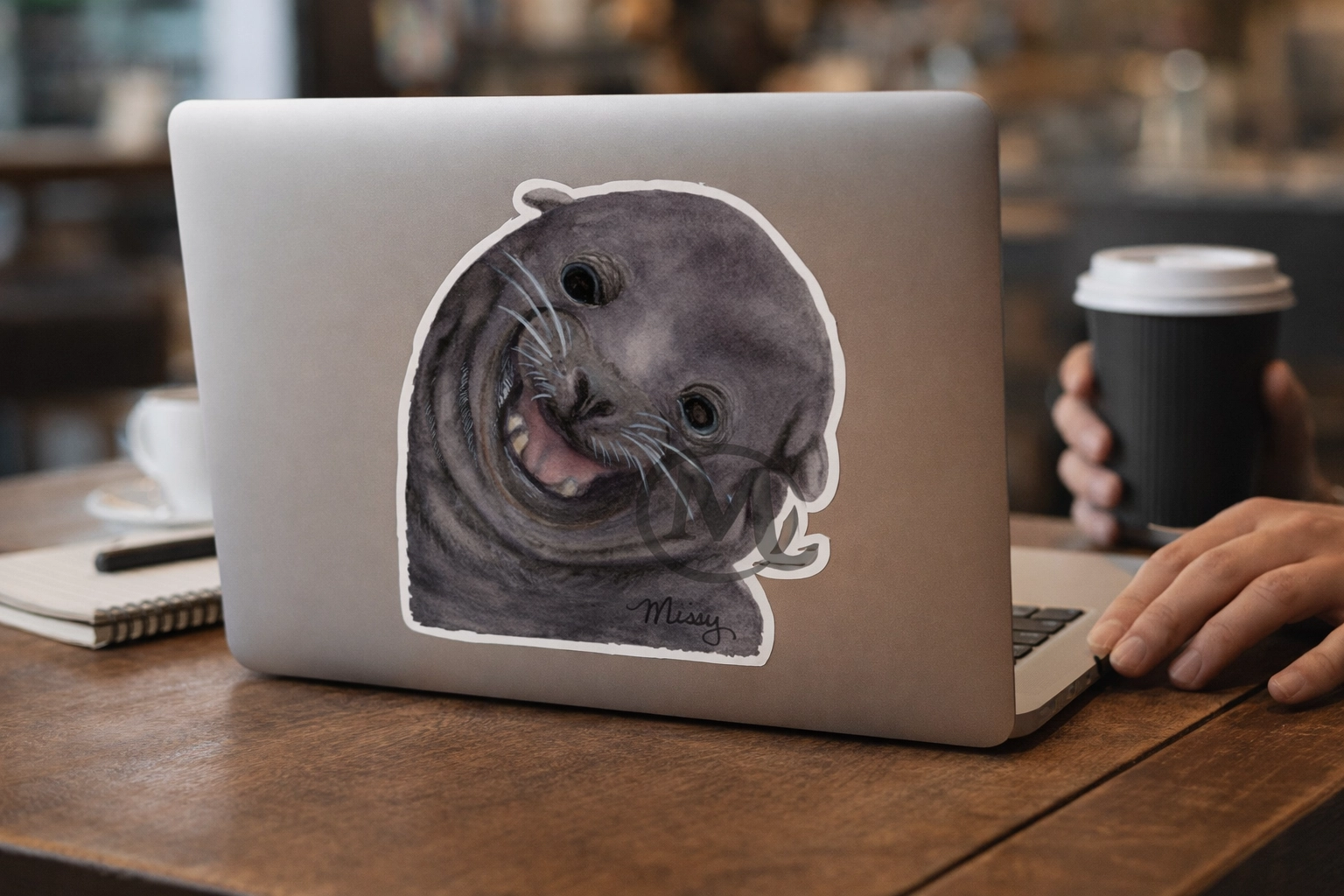 Smiling seal sticker mockup on a laptop