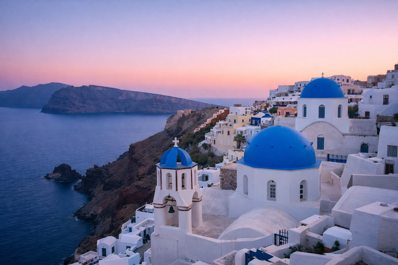 Blue hour view of Oia Santorini’s white buildings and blue domes, one of the best photography locations.