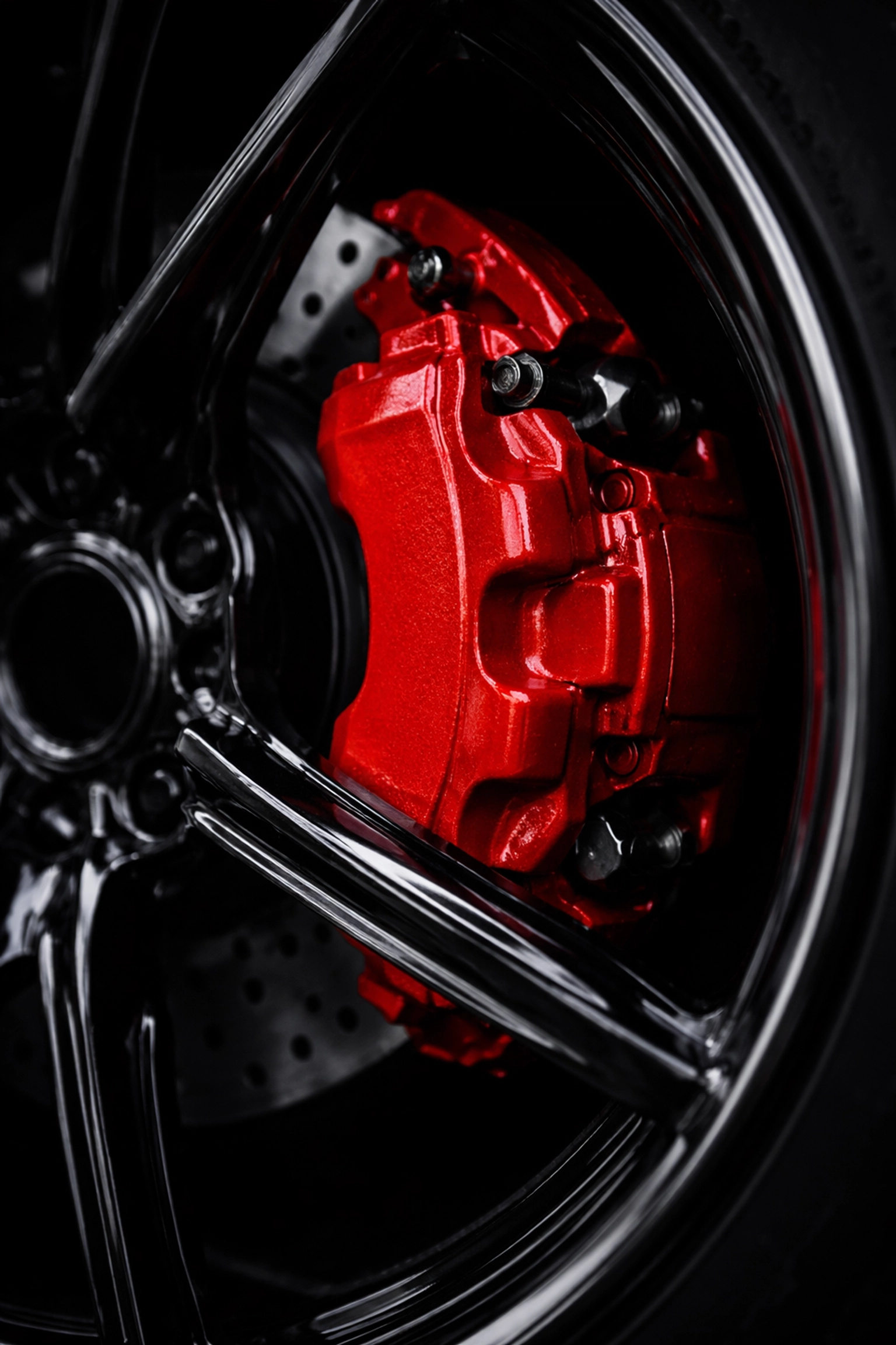 Red powder-coated Mopar brake caliper behind black wheel, highlighting factory color matching and durable finish