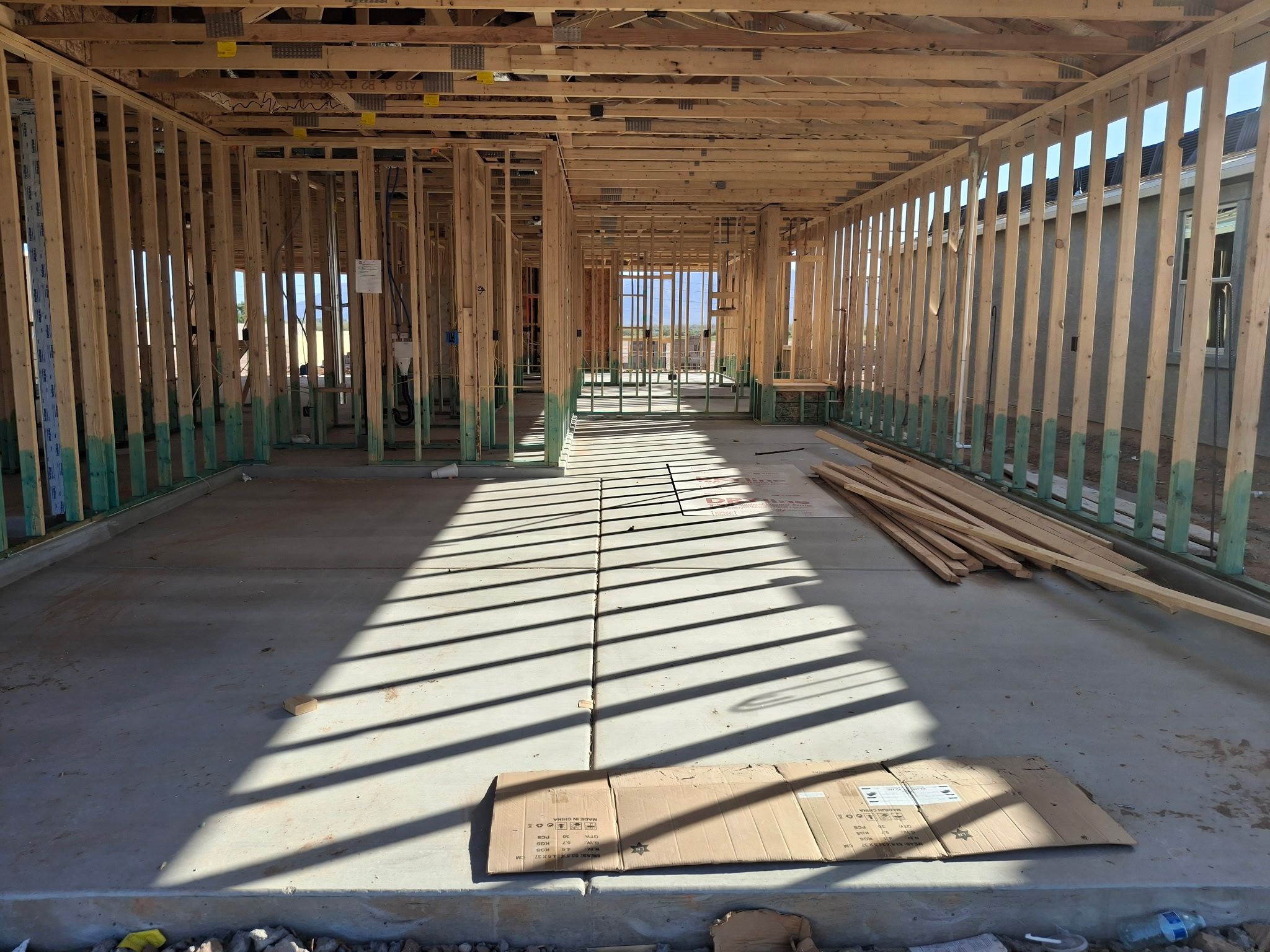 Exposed wood framing and concrete slab in a new Arizona home under construction