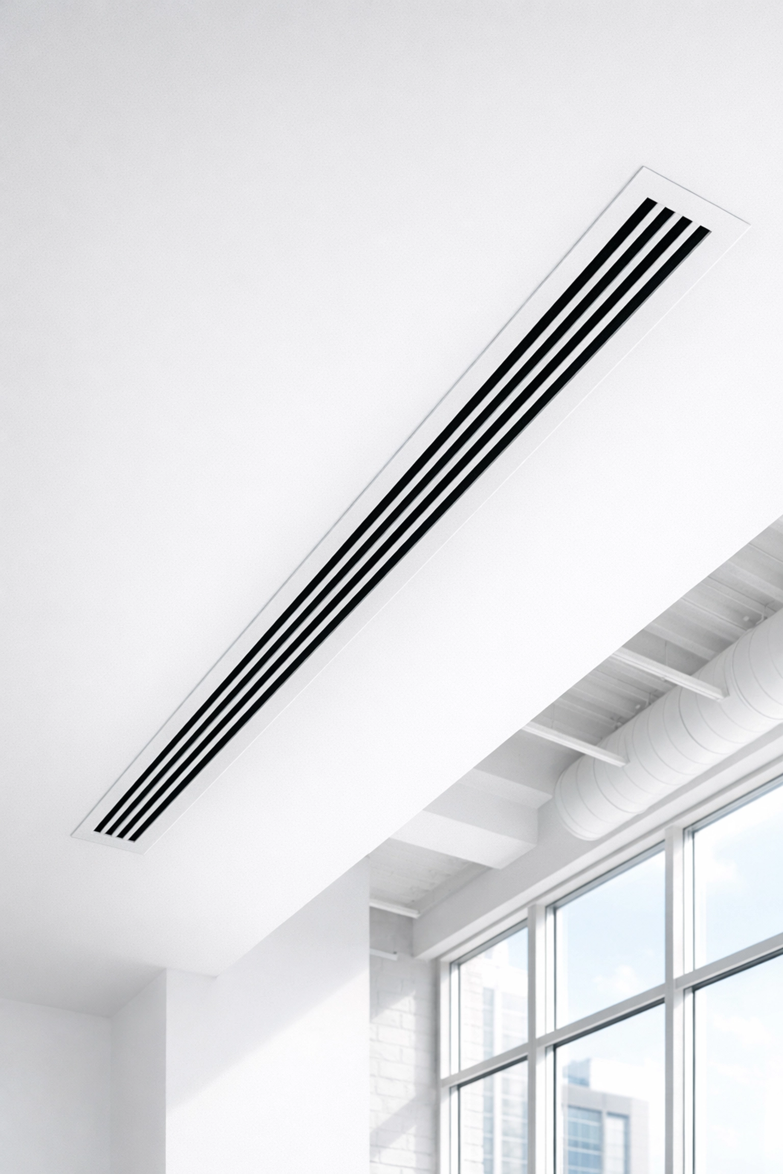 A clean white HVAC air vent in a Detroit office ceiling, highlighting improved building air quality.
