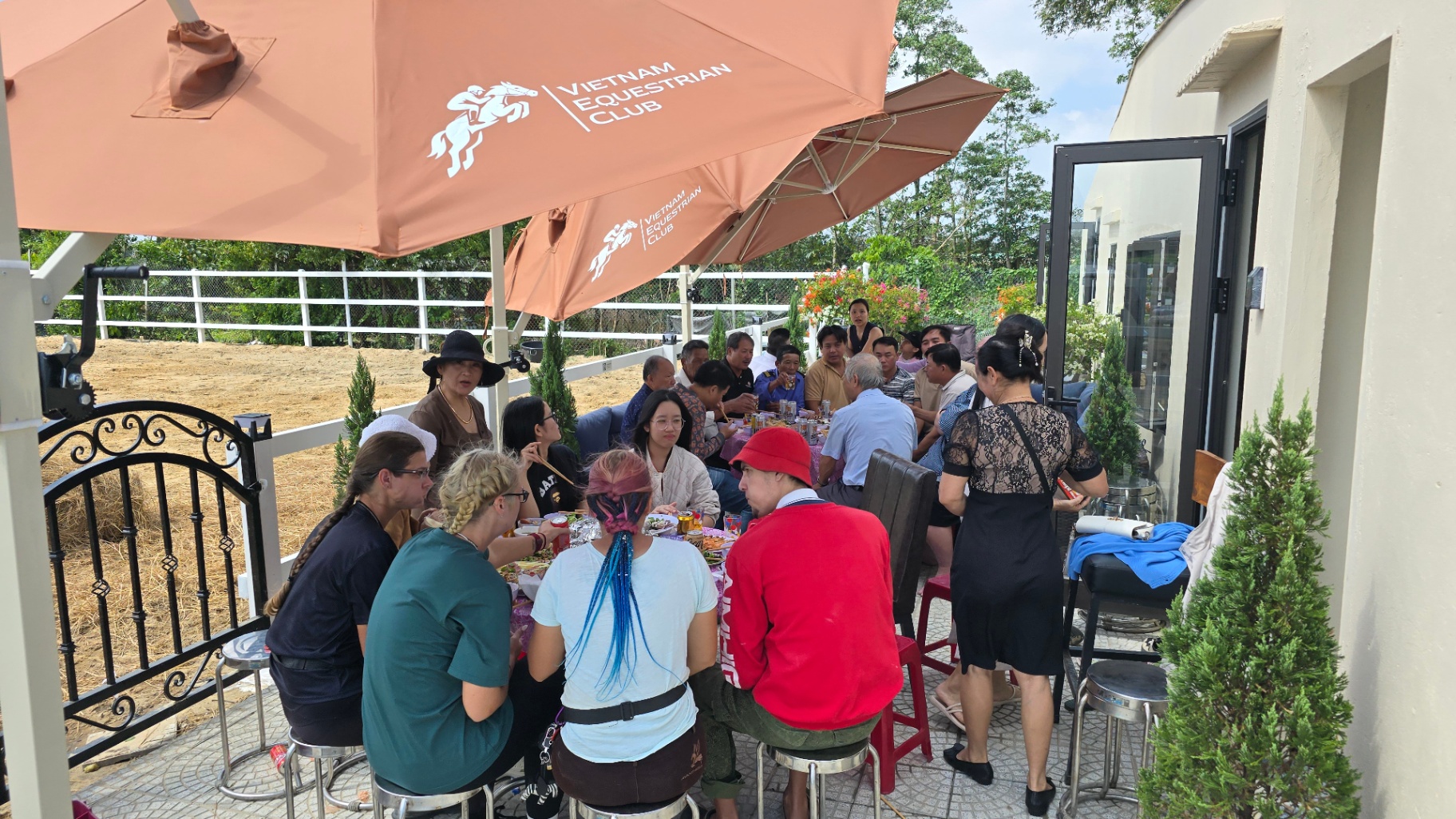 Guests gathering on the patio at Vietnam Equestrian Club