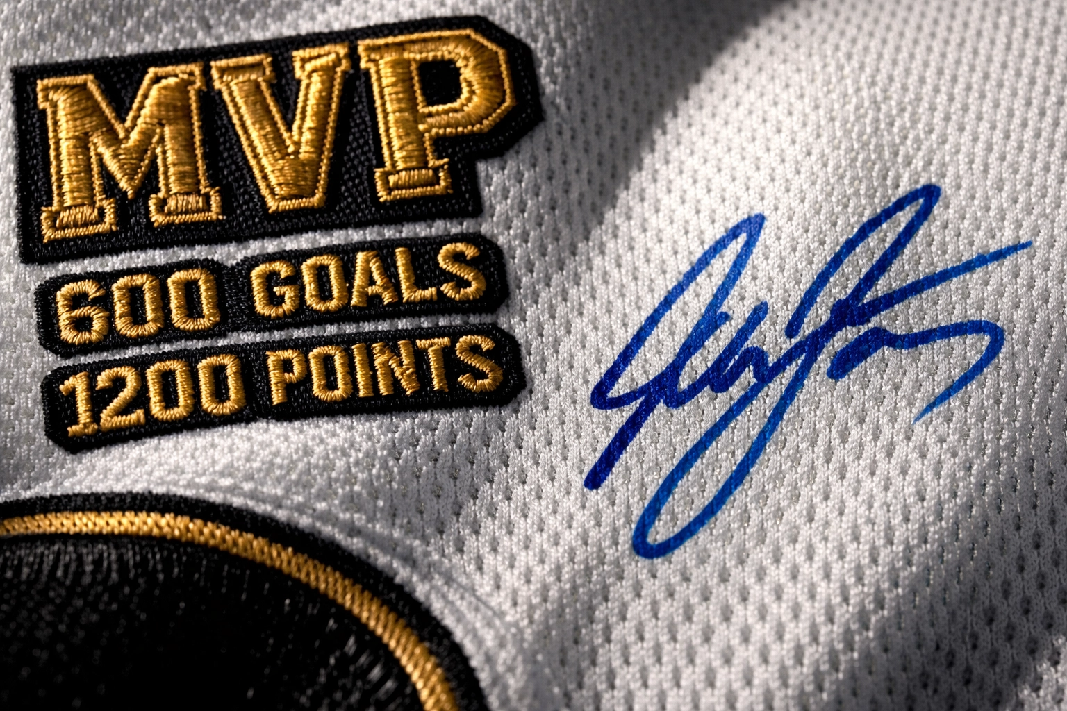 Detailed view of the embroidery and signature on an authentic sports memorabilia career jersey.