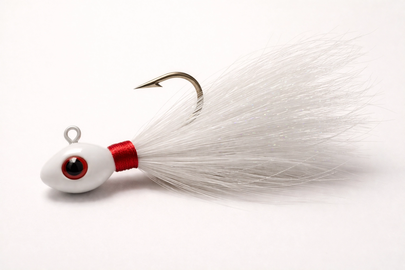 Traditional fixed hook bucktail jig with white bucktail fibers photographed on a rustic dock