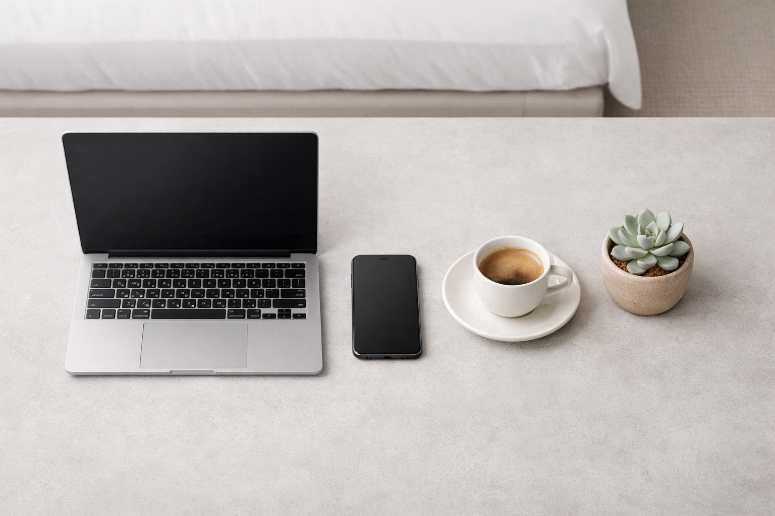 Minimalist boutique hotel workspace with a smartphone optimized for frictionless direct bookings.