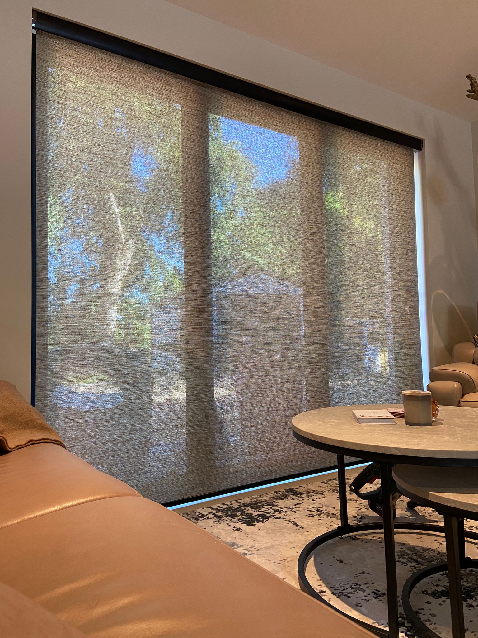 Custom in-house manufactured sheer roller blinds installed on a large living room window