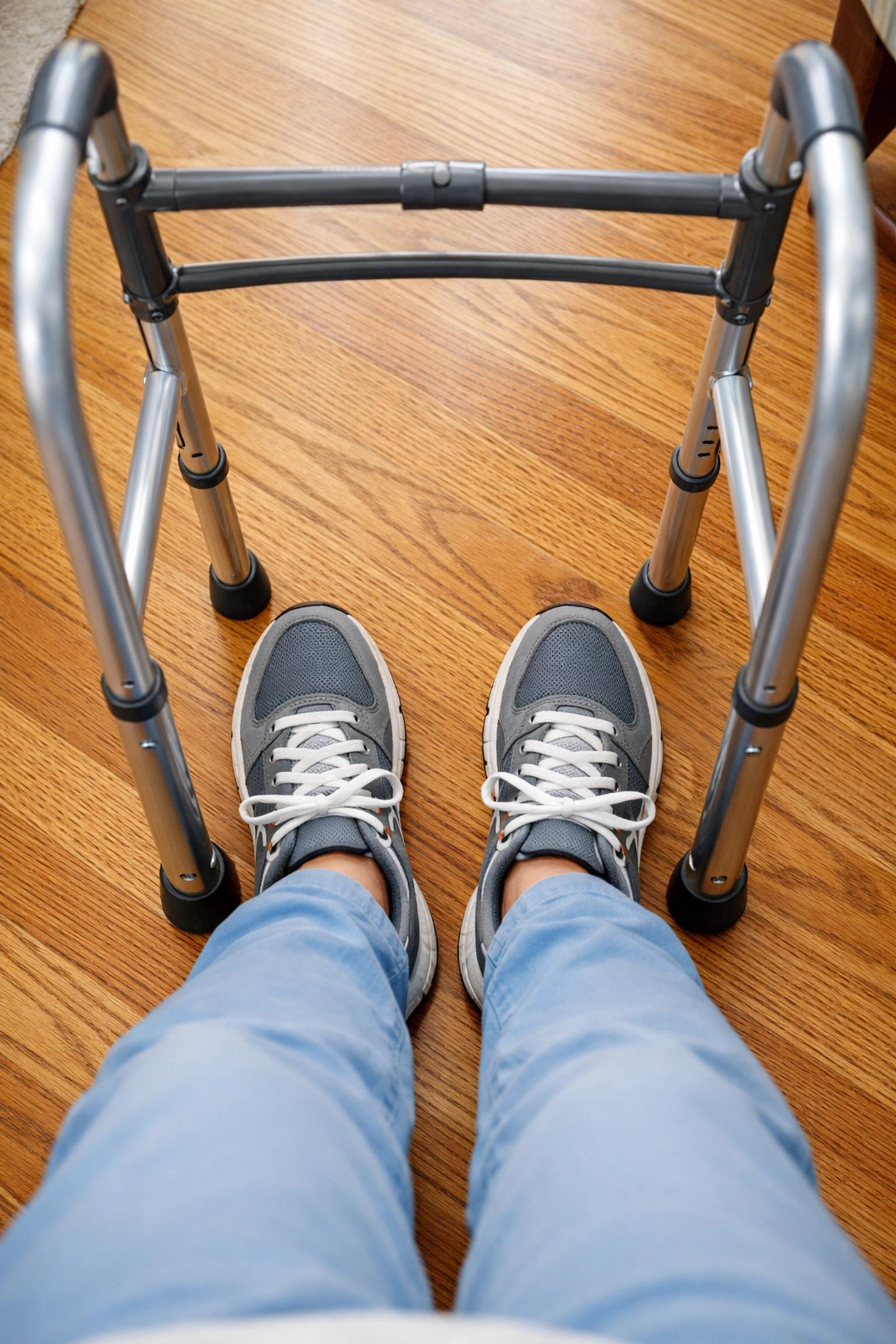 Proper walker use showing a person's feet staying safely inside the walker frame while walking.