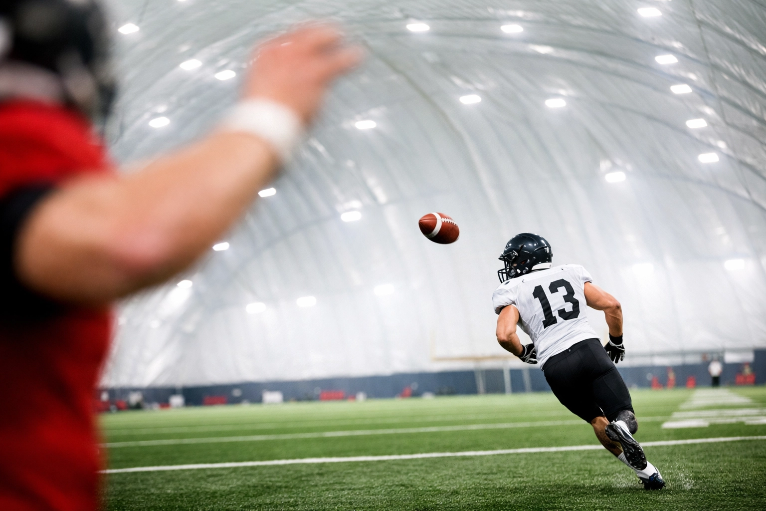 Quarterback and receiver building timing and chemistry in the New Garneau Dome in Orleans.