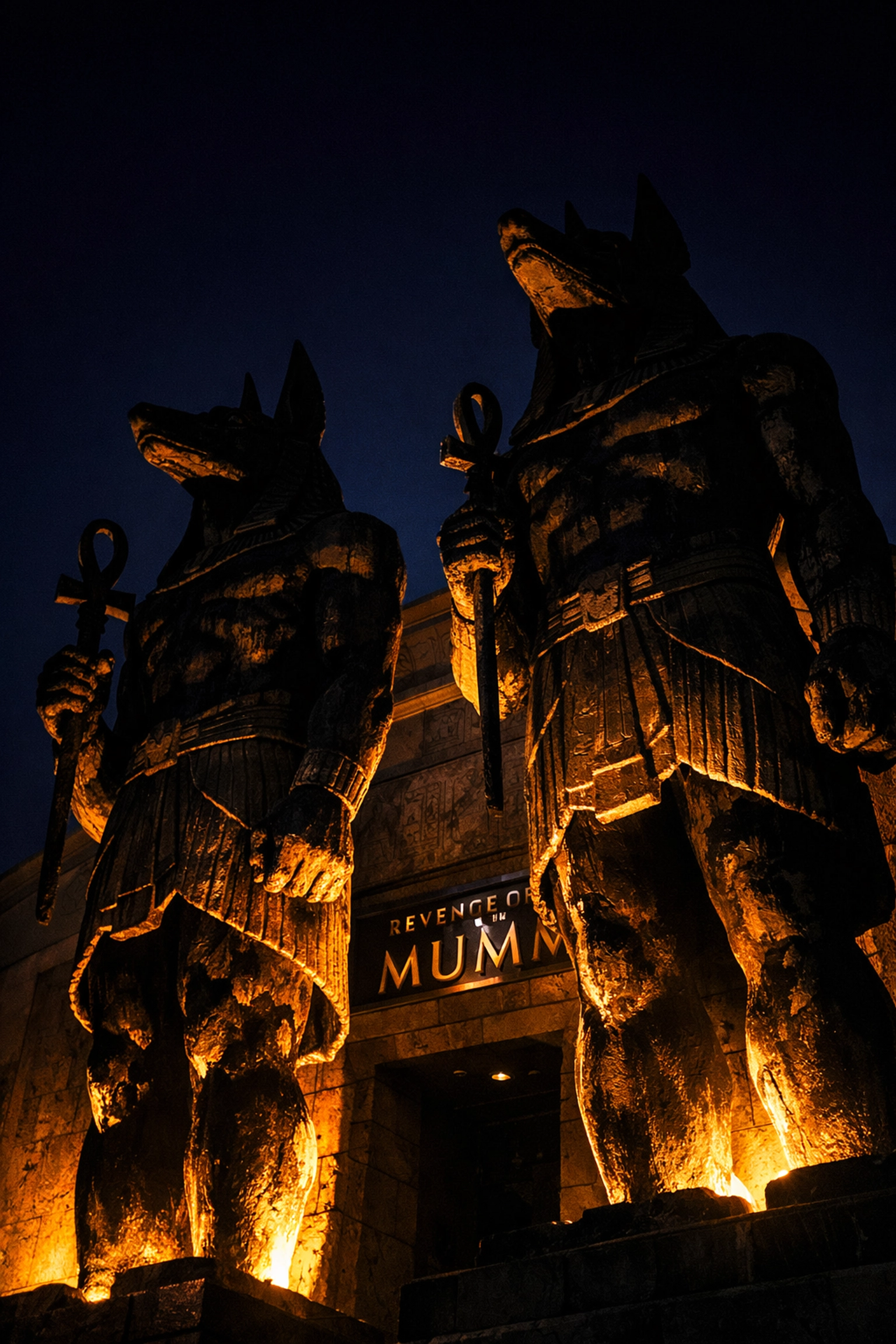 Night silhouette of massive Egyptian statues at Revenge of the Mummy, a dramatic photo spot at Universal Studios Hollywood.