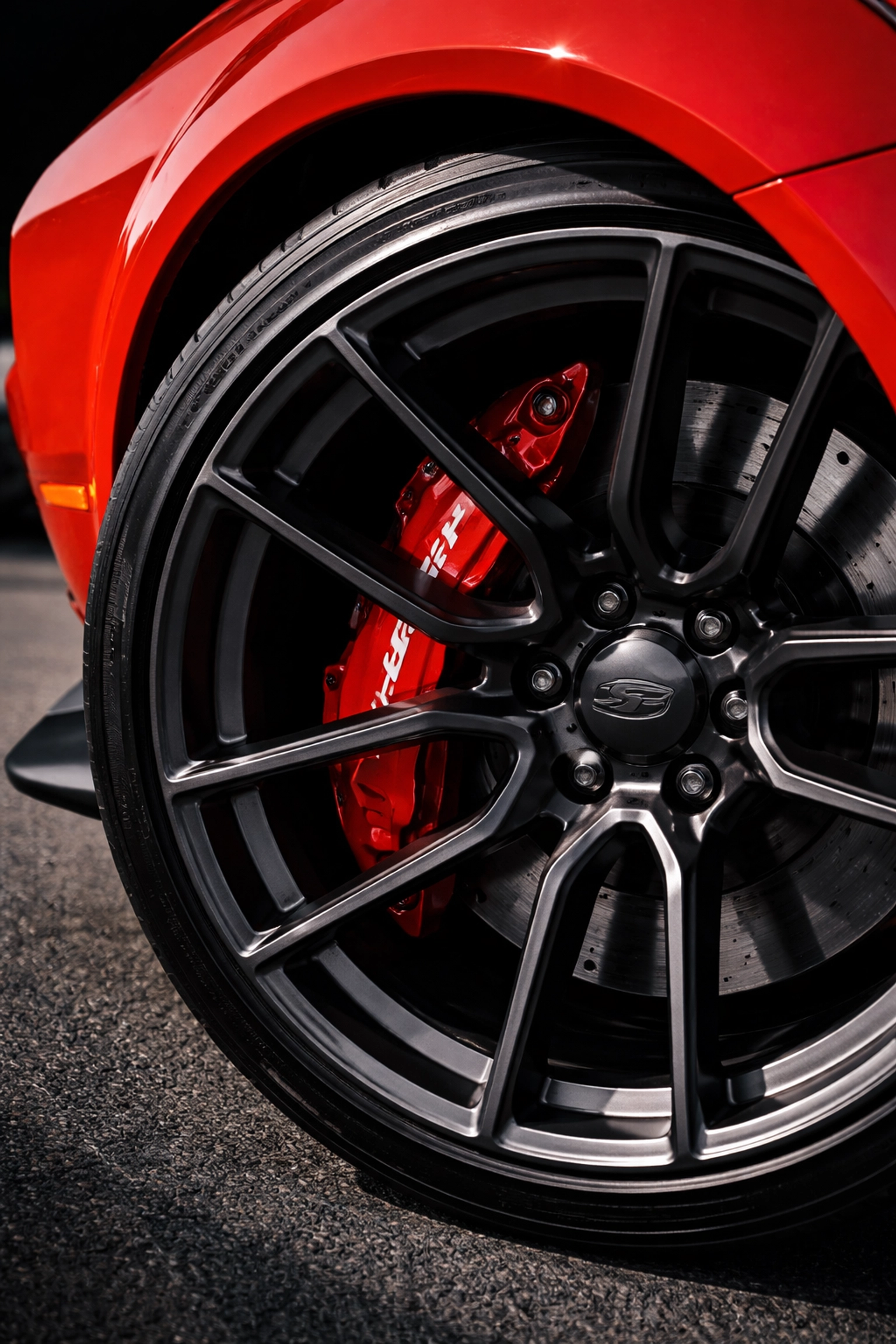 Powder-coated TorRed brake caliper on a Dodge Challenger SRT, demonstrating factory color match and premium finish.