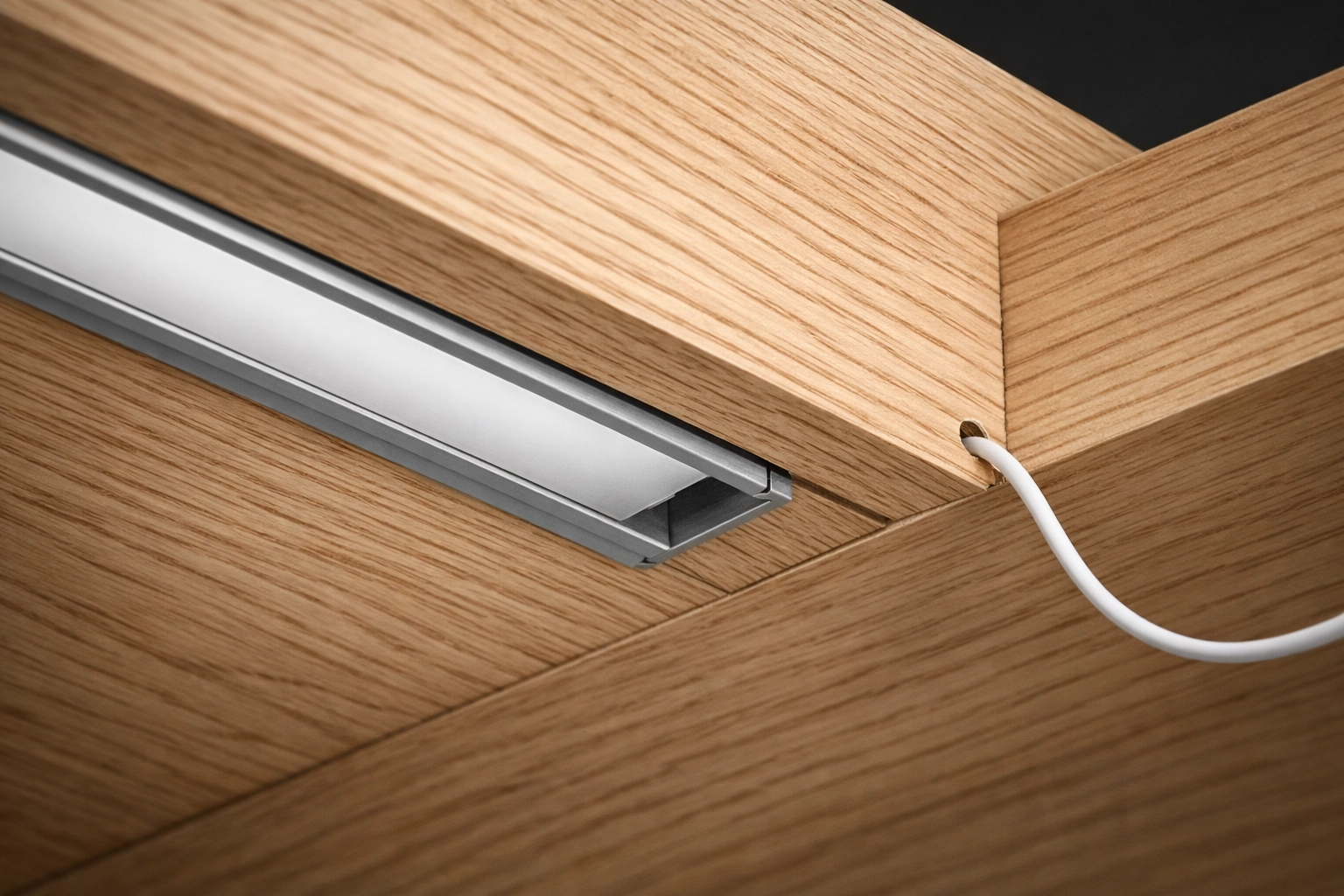 Hidden kitchen cabinet lighting wiring routed through a custom wood groove for a seamless installation.