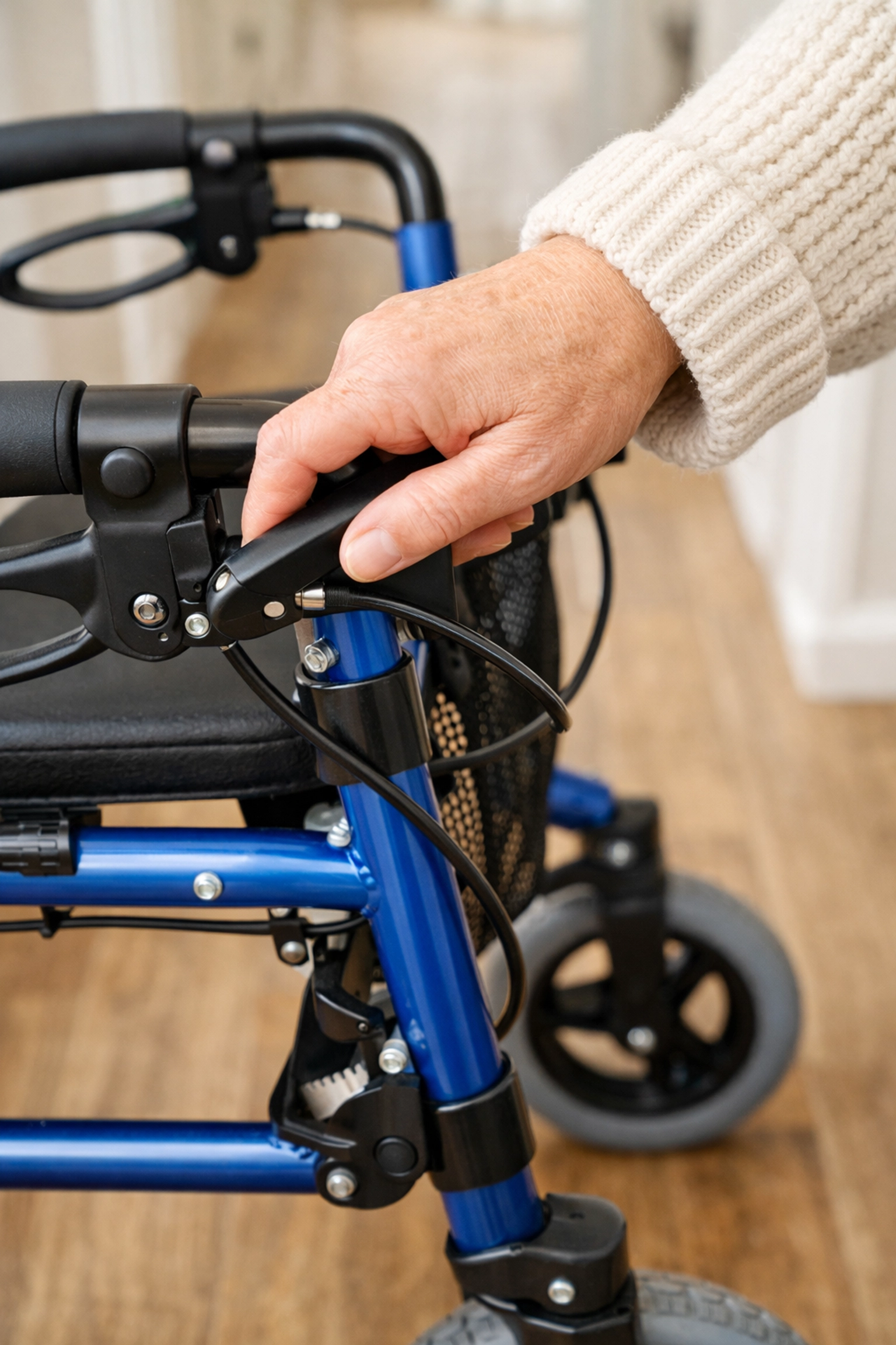 Close-up of a hand engaging the safety locking brakes on a rollator walker for stability.