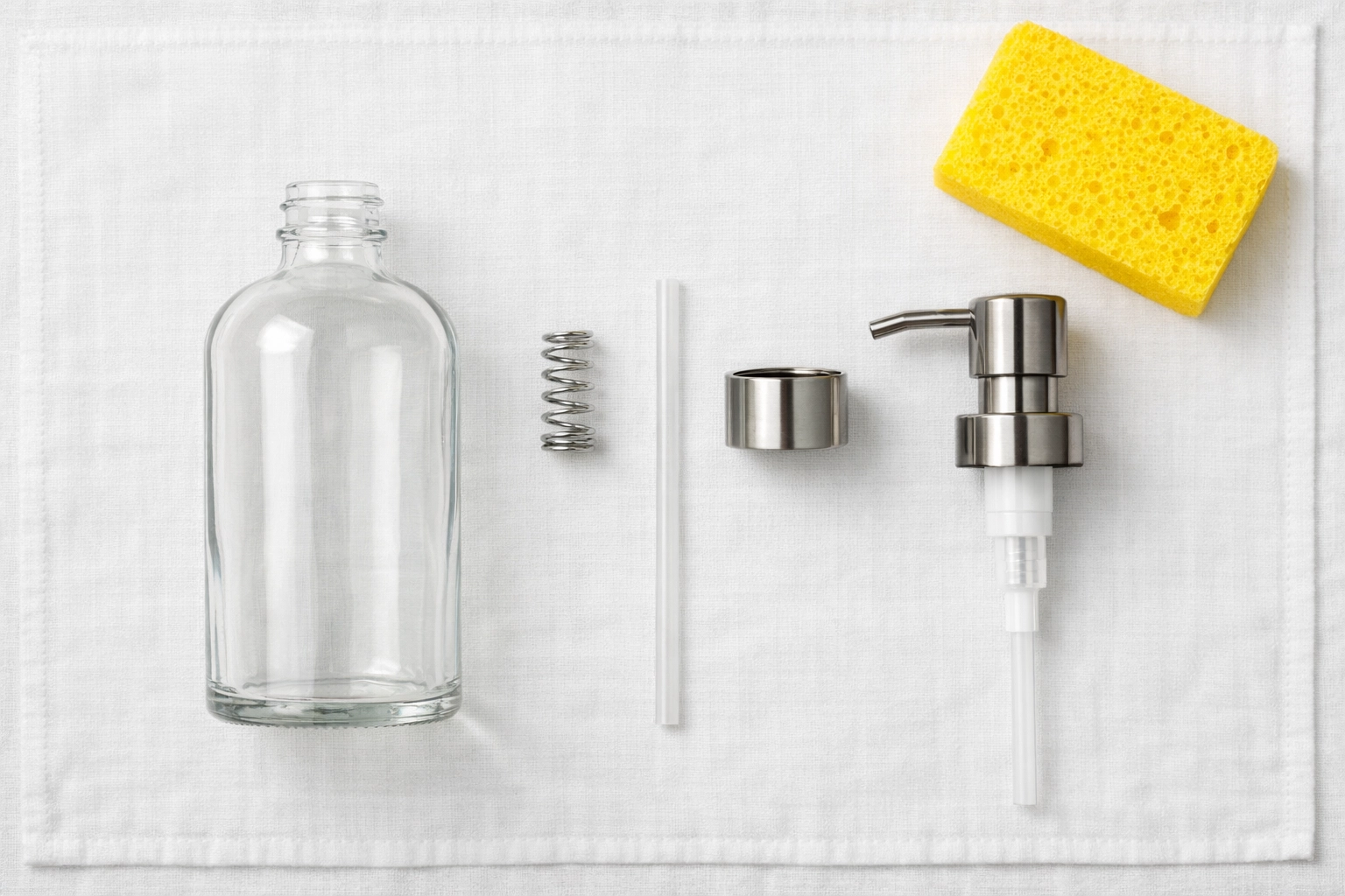 Disassembled soap dispenser parts organized for a thorough weekly house cleaning.