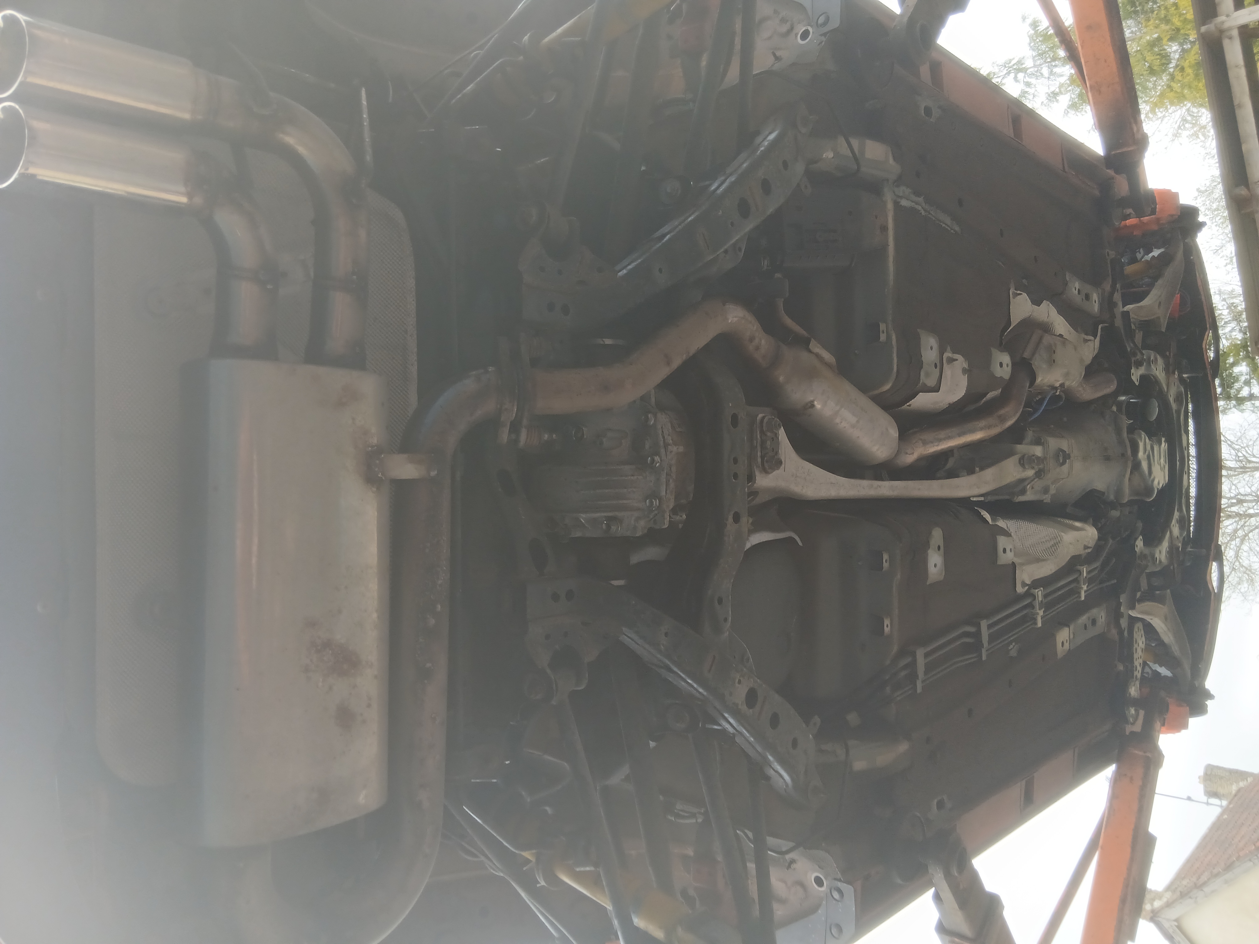 Professional rust inspection showing surface corrosion on a vehicle chassis