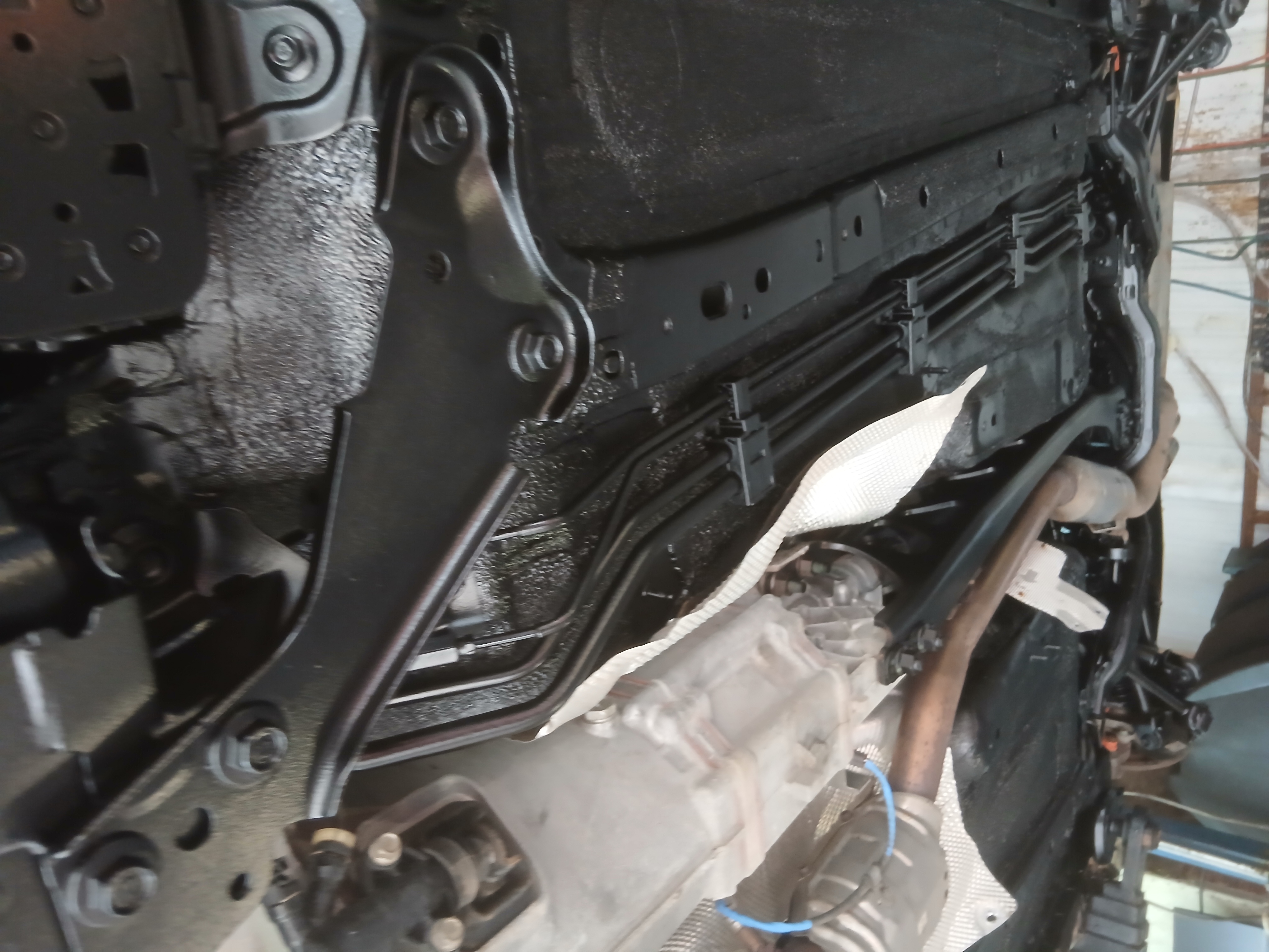A view of a vehicle underbody after the professional Rustec Elite Standard treatment