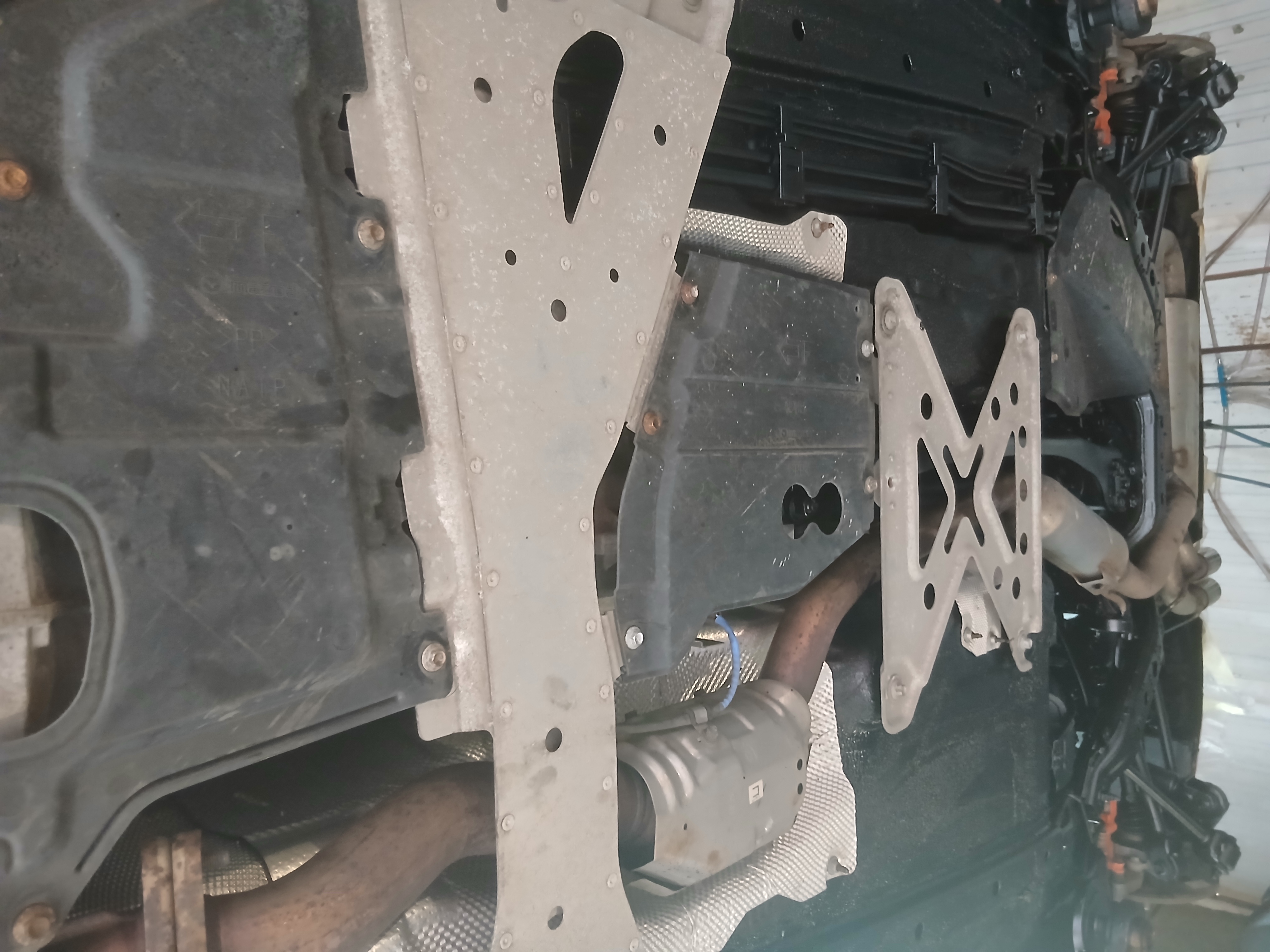 A fully protected undercarriage including skid plates and suspension