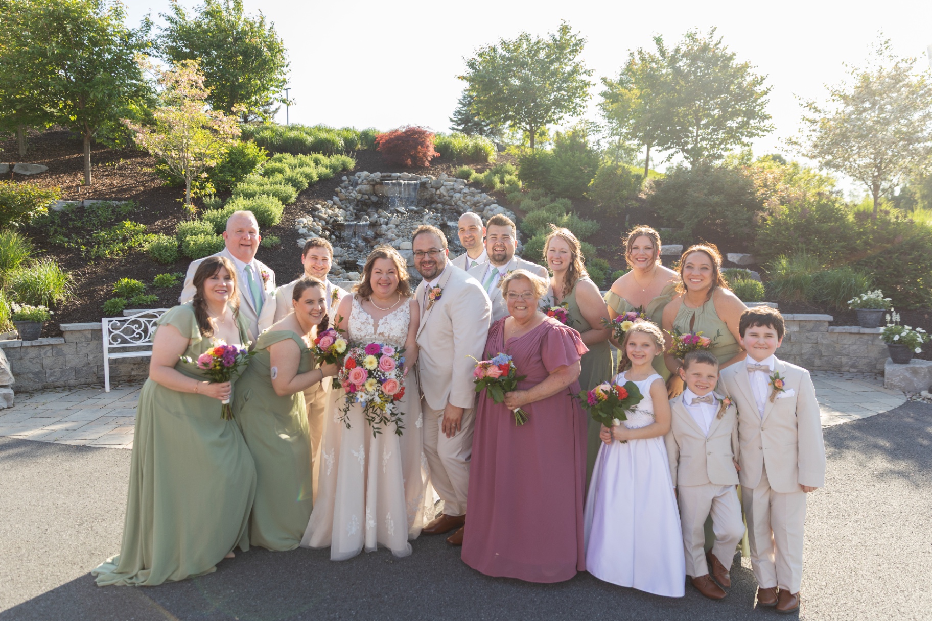 Wedding party outdoors—bright bouquets, big smiles, and everyone ready to celebrate