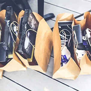 Brown paper bags filled with a variety of branded promotional items