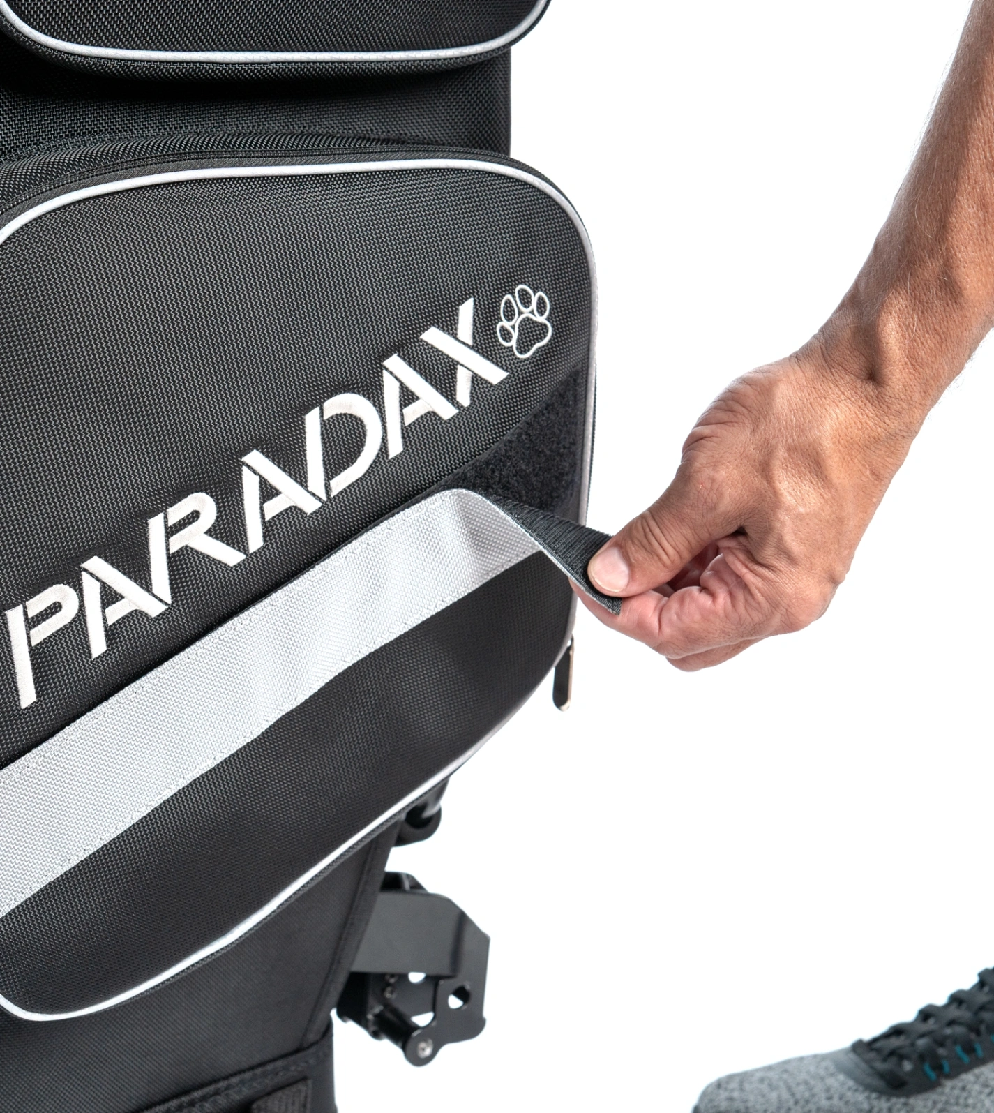 PARADAX AI-1 golf bag close-up Close-up image showing a user opening a Velcro pocket on the PARADAX AI-1 golf bag. The image highlights the bag’s durable construction, easy-access storage, and signature branding with customizable color options.