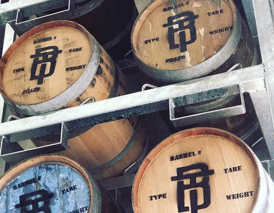 Rows of Tiny Bear Distillery’s small-batch spirit barrels