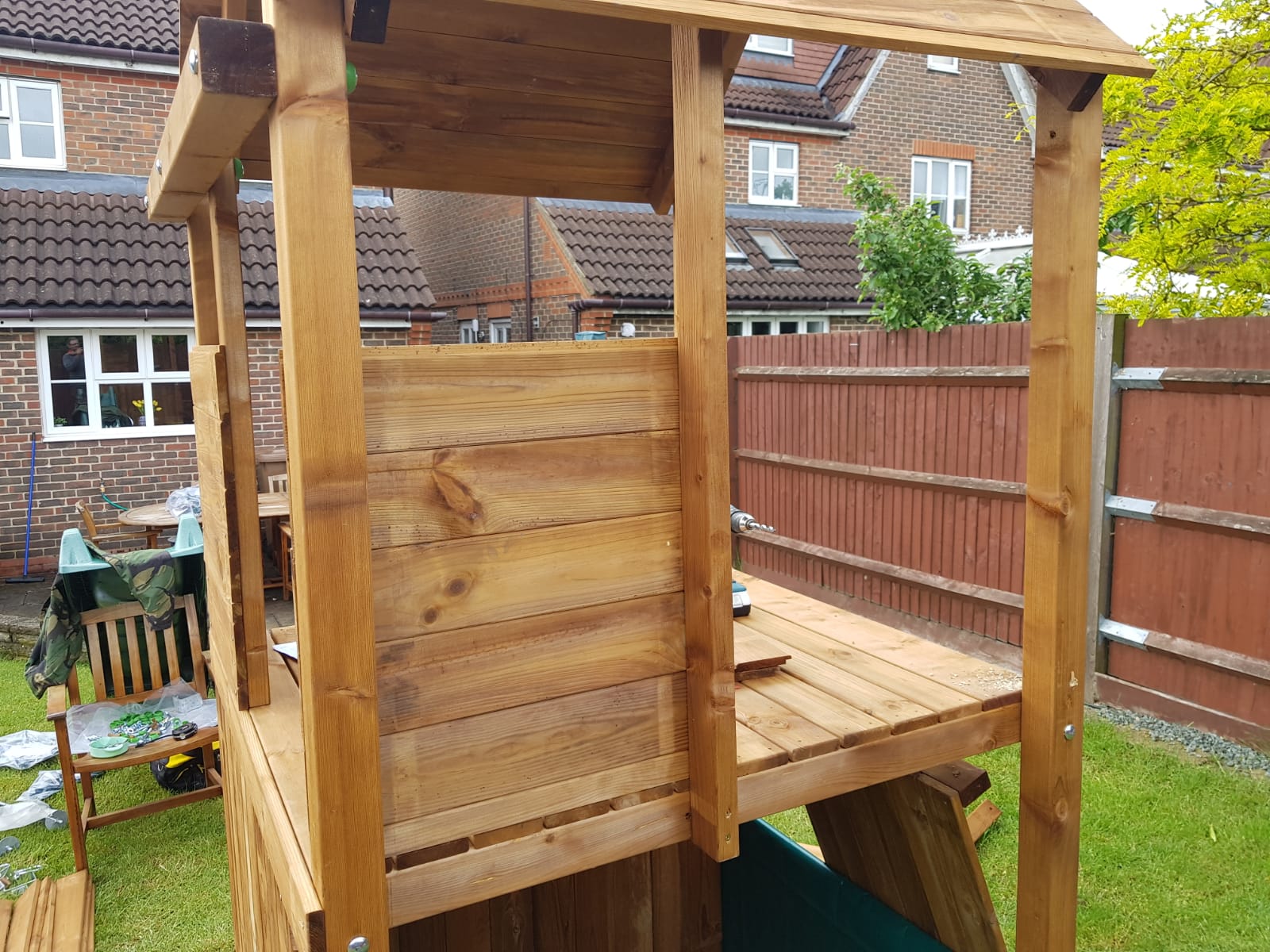 Partially assembled wooden climbing frame installation