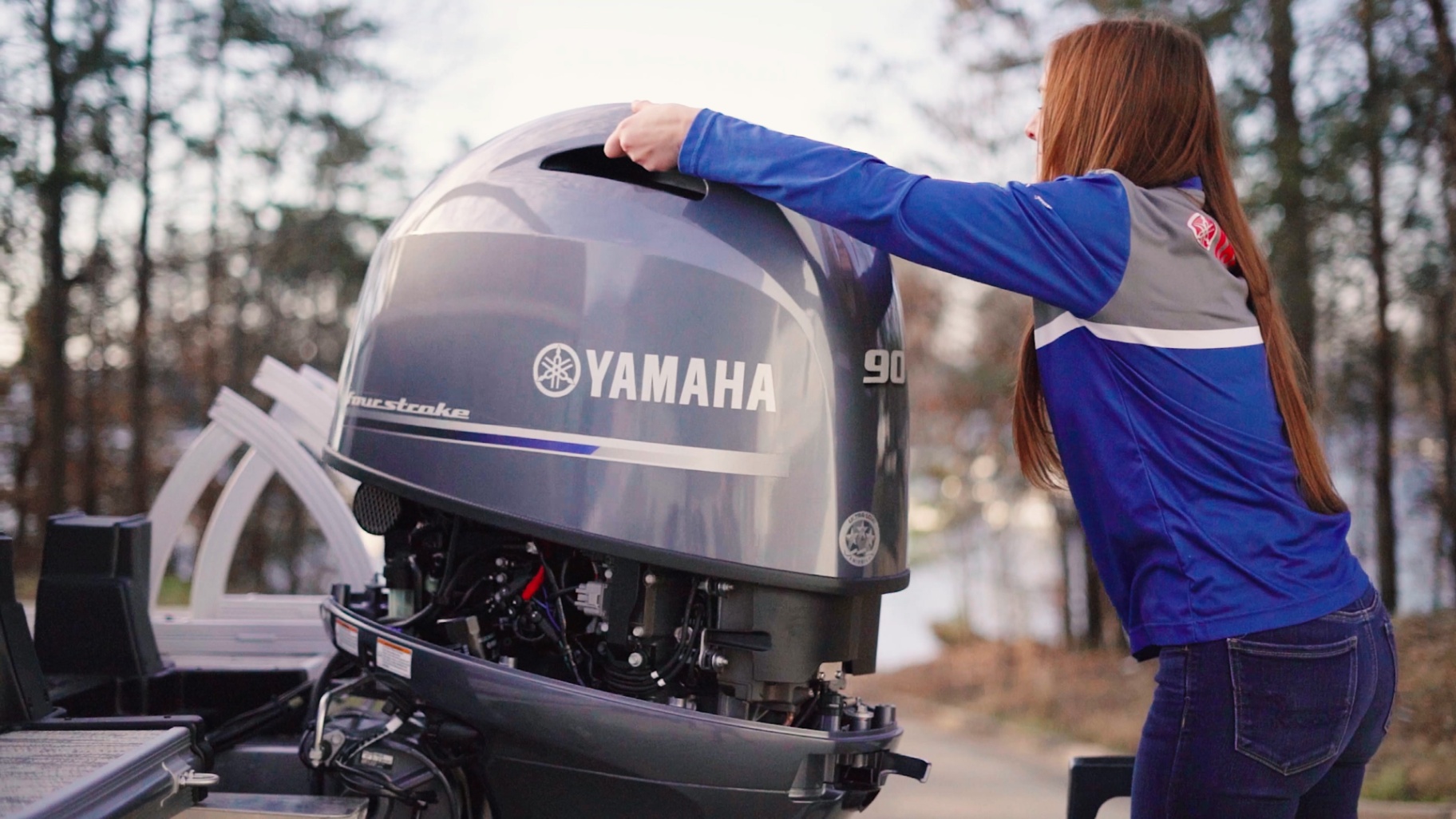 Technician inspecting Yamaha 90HP outboard engine