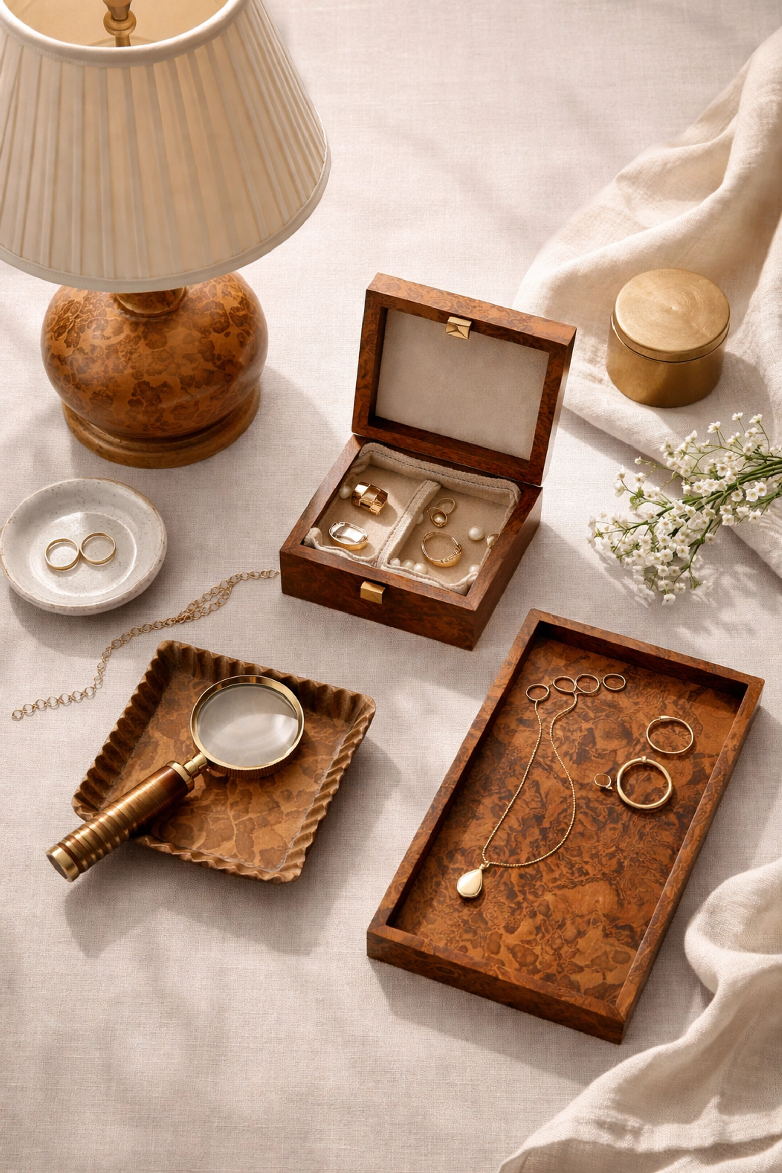 Curated burl wood home accessories including jewelry box and decorative tray with brass accents