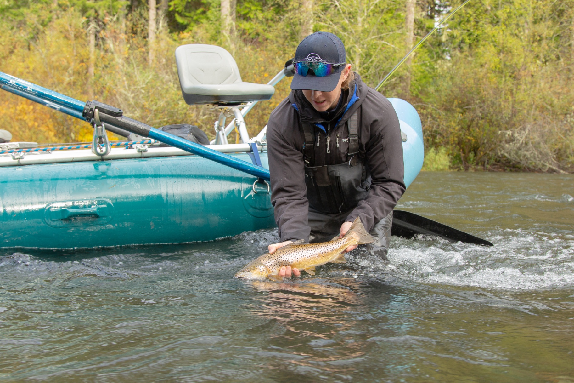 Guest fishing from a drift boat on the Cowichan River
