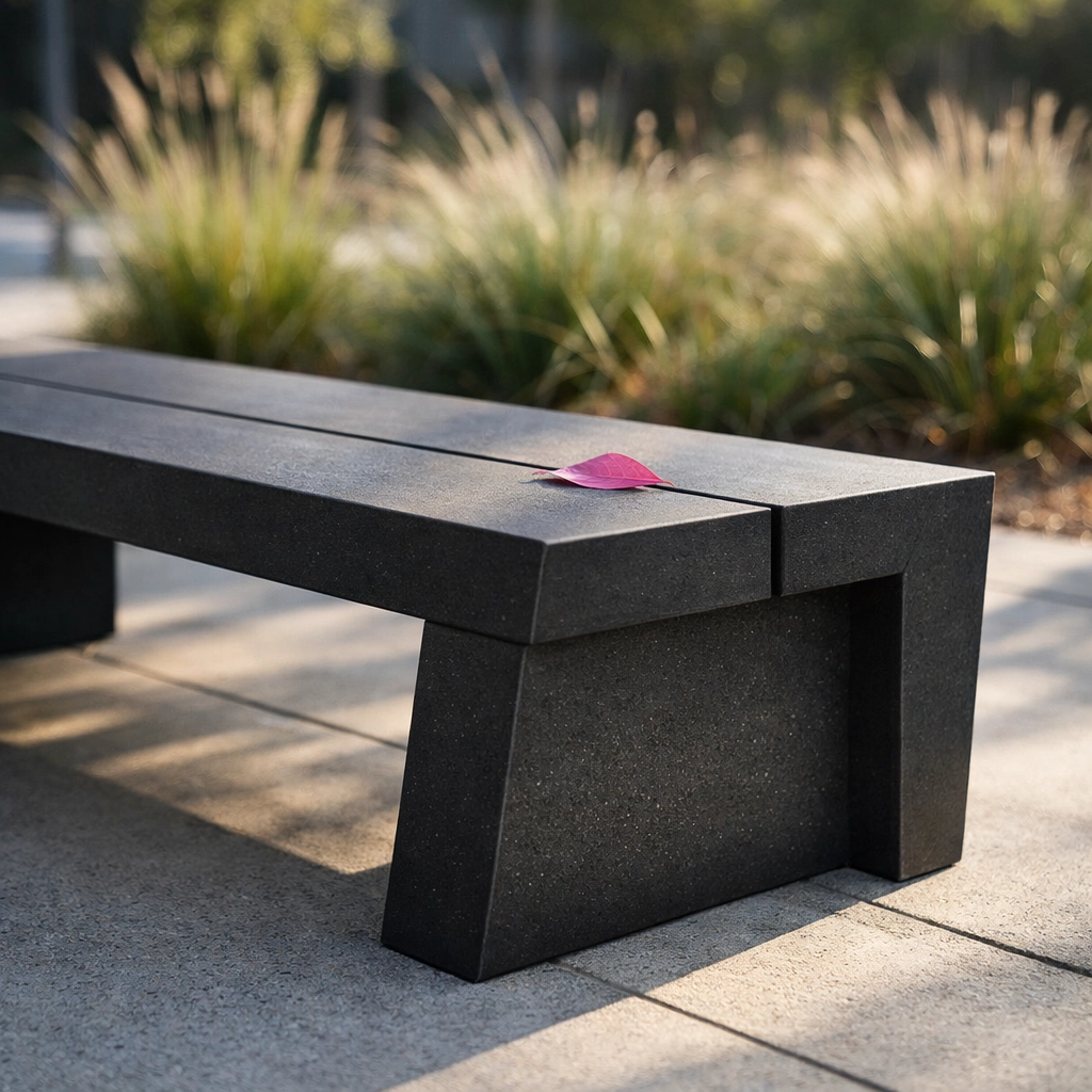 Maintenance-free public park bench made from 100% recycled plastic panels in a modern urban park.