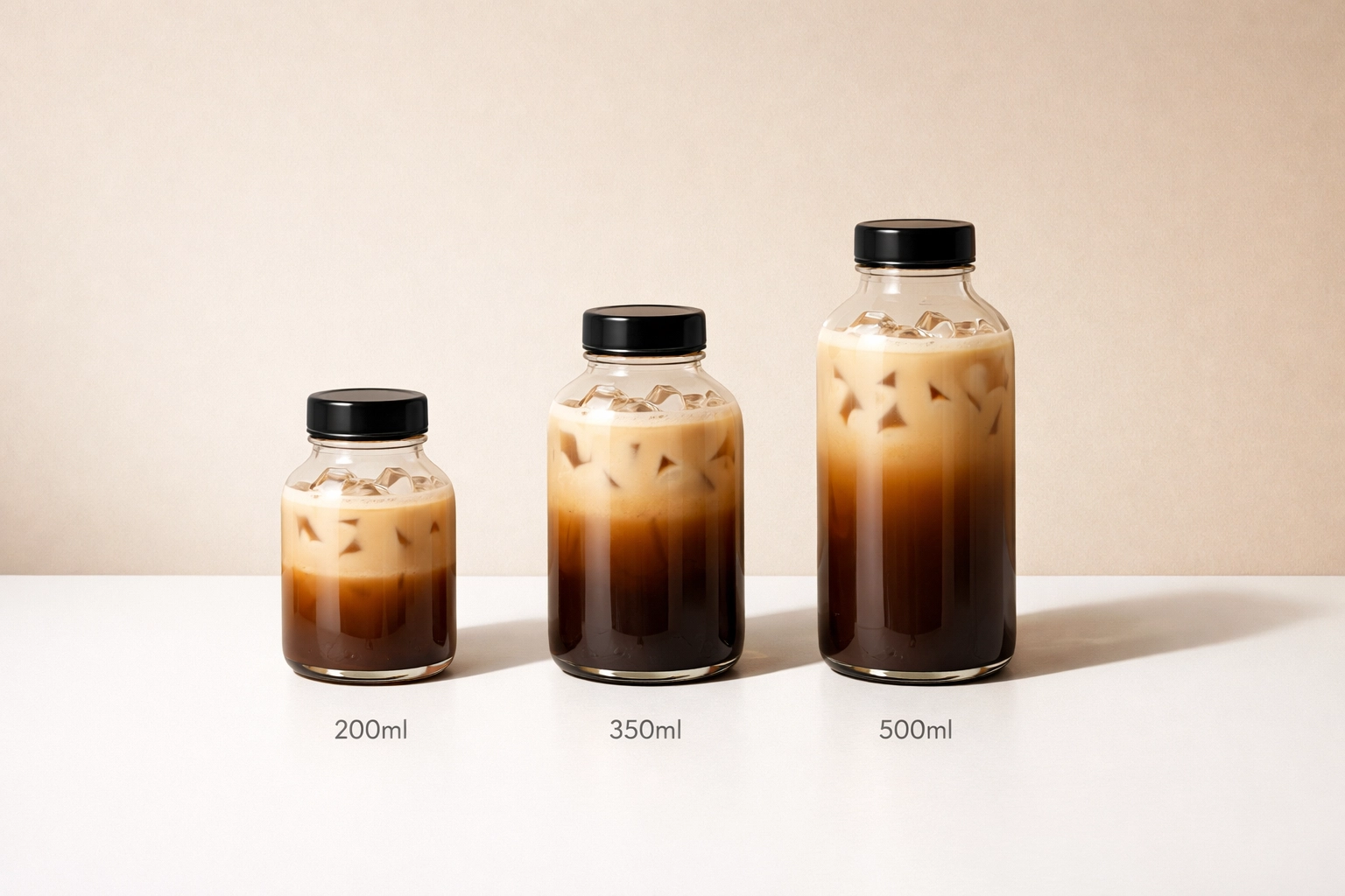 Three glass bottles of cold coffee in different sizes: 200ml, 350ml, and 500ml