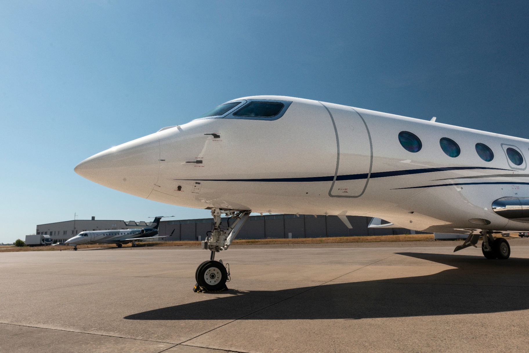 Modern ultra-long-range jet and midsize jet parked on the tarmac, reflecting the vetted operator network Jet Members uses