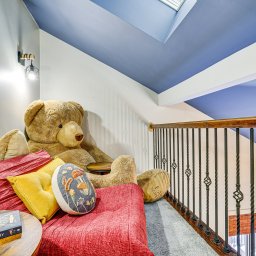 Bernie the bear hand-painted artwork at Bearly Roughing It cabin entrance