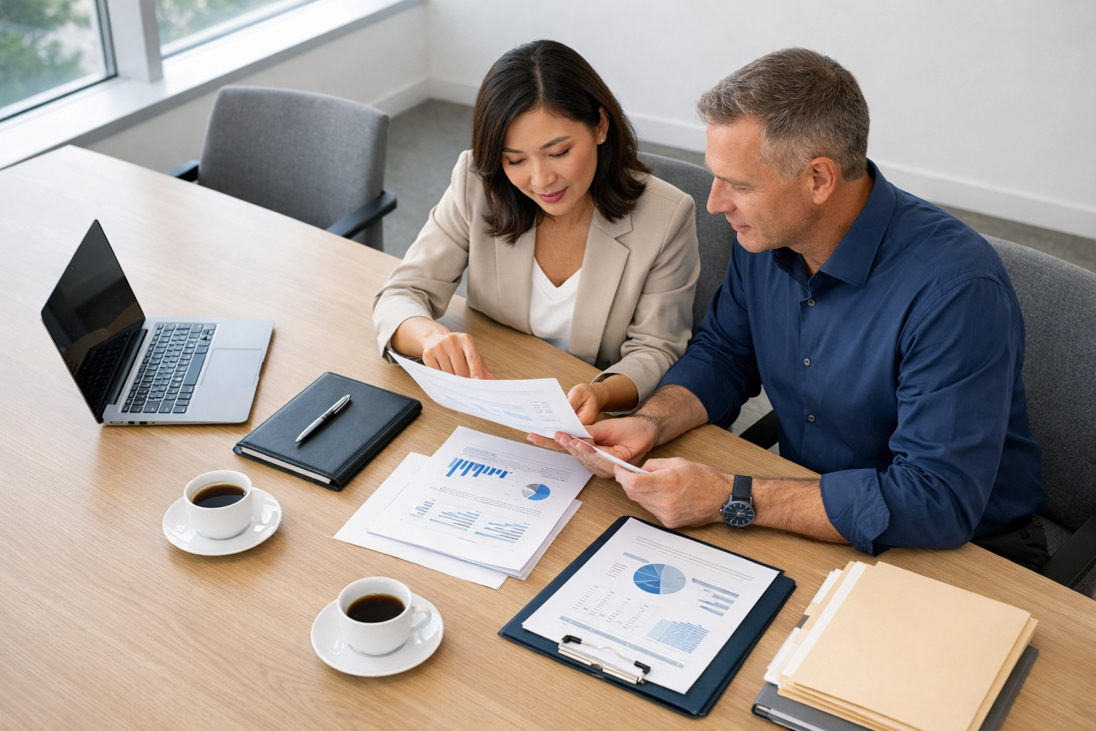 Tax professionals reviewing client documents and configuring ERO workflow procedures together