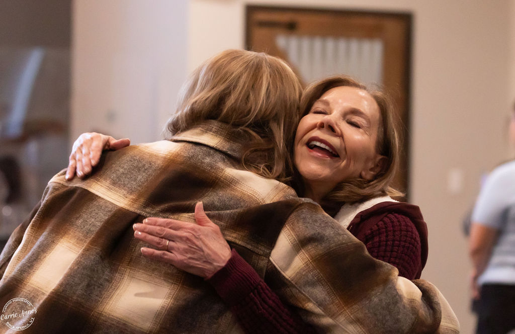 Two Women Embracing in Church
